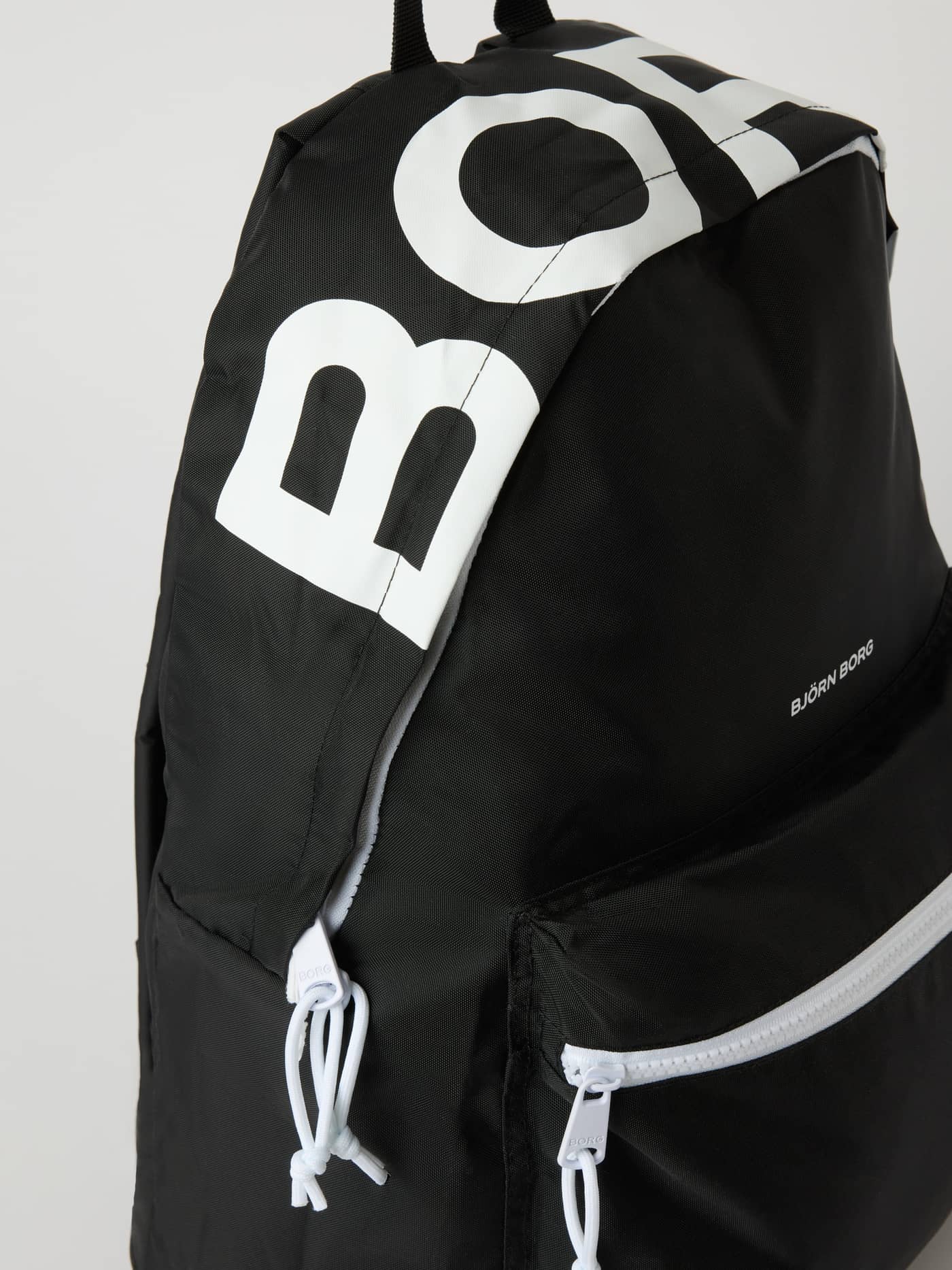 Angled view of the Borg Logo Backpack 27L in Black Beauty (Black) featuring a large white logo and recycled polyester. - Image 3