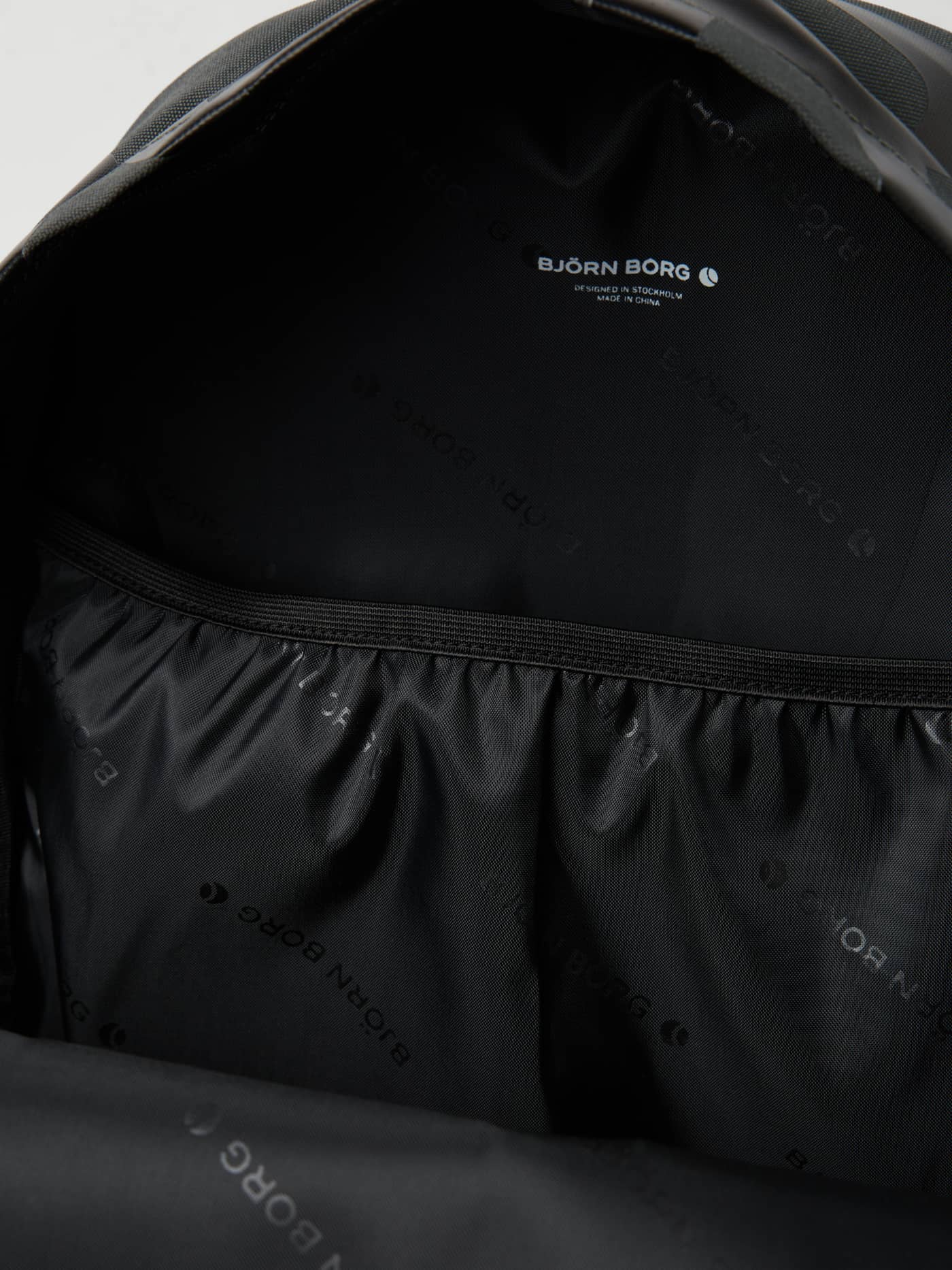 Inside the Borg Logo Backpack 19L in Forest Night (Green) featuring a logo print lining and laptop sleeve for training. - Image 3