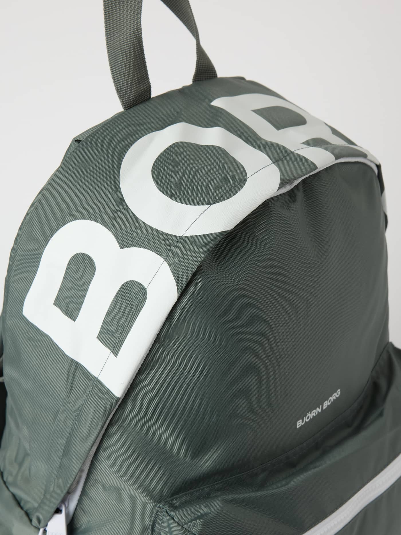 Close-up view of the Borg Logo Backpack 27L in Balsam Green (Green) featuring a large white logo print on top. - Image 3