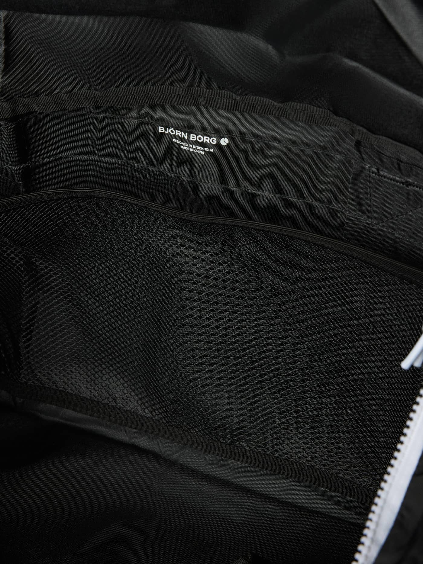 Interior view of the Borg Logo Sports Bag 42L in Black Beauty (Black) with a mesh pocket and white logo. - Image 5