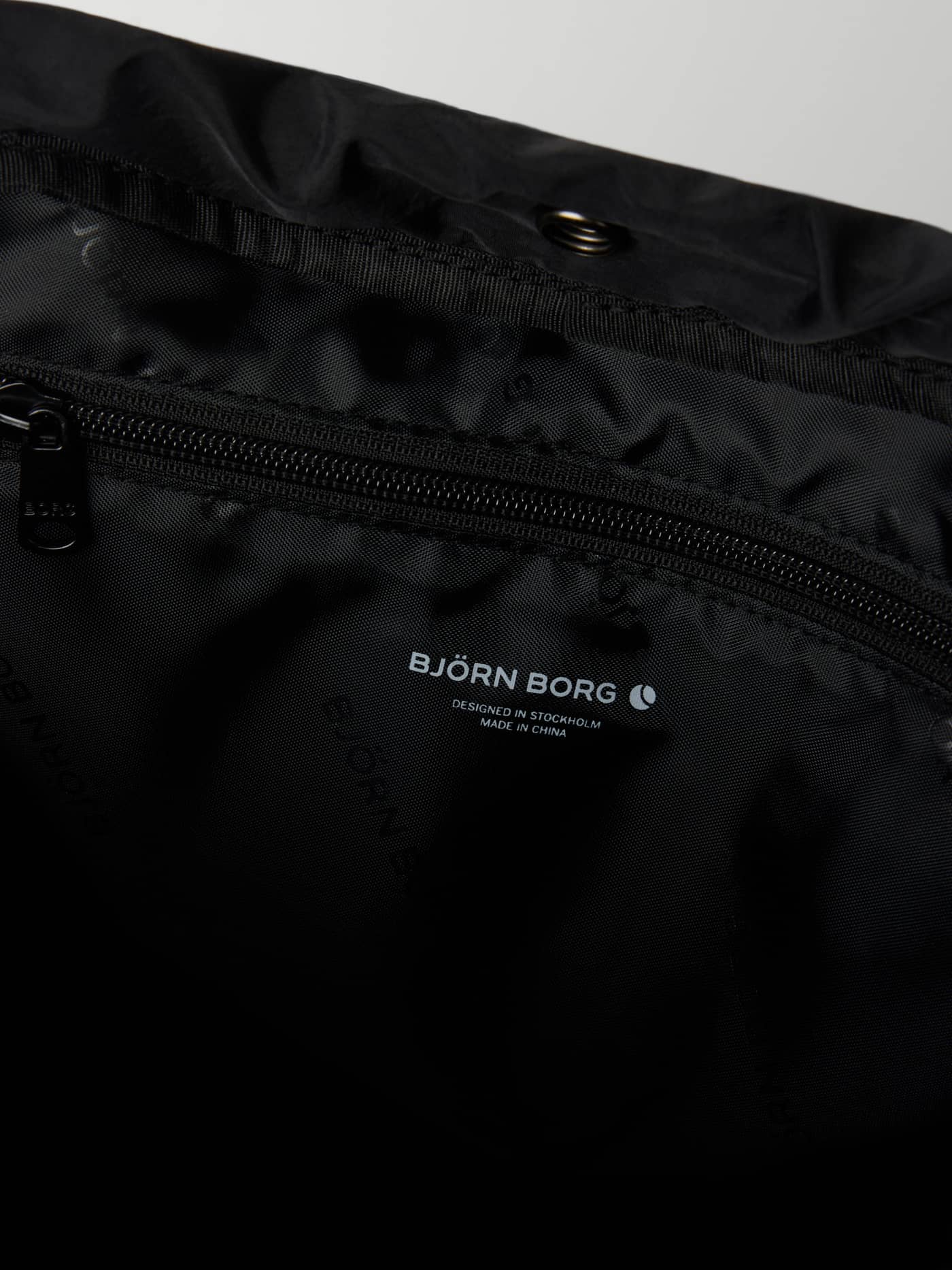 Internal view of the Studio Active Tote 18L in Black Beauty (Black) showing the zip pocket for training gear. - Image 3