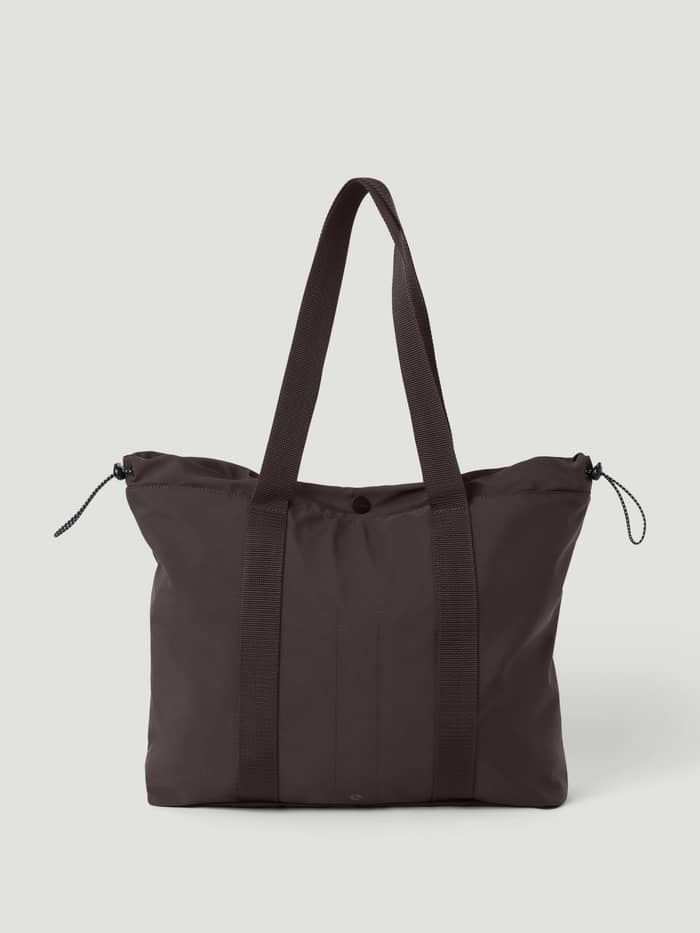 Studio Active Tote 23L in Coffee Bean (Brown) featuring side drawstrings and top handles for training and studio use.