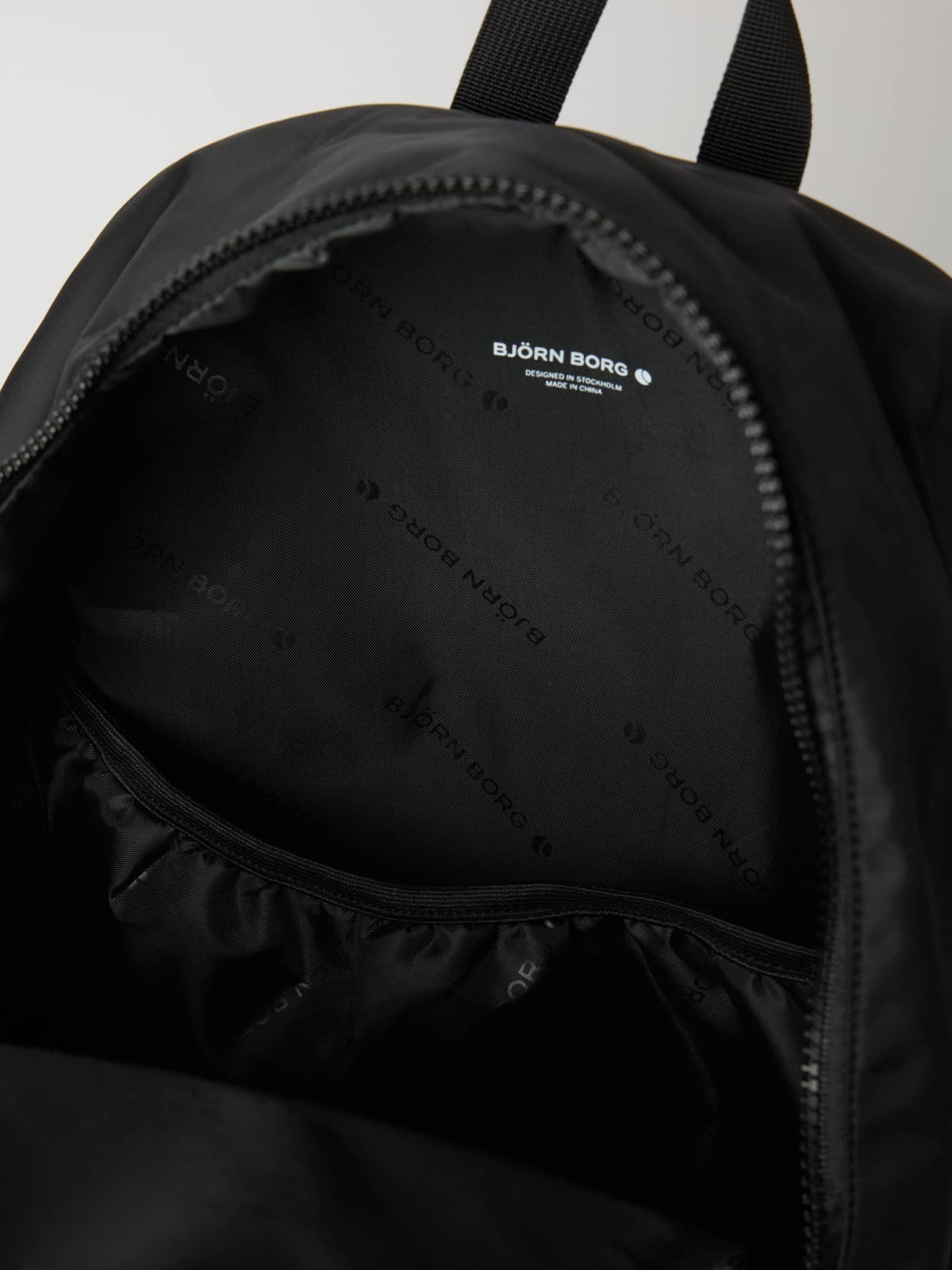 Interior view of the training Borg Classic Backpack 19L in Black Beauty (Black), showing the branded lining and white logo. - Image 3
