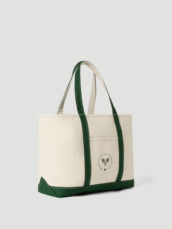 Ace Canvas Tote 30L in Egret (White), a durable cotton canvas tennis bag featuring green straps and a front racquet logo.
