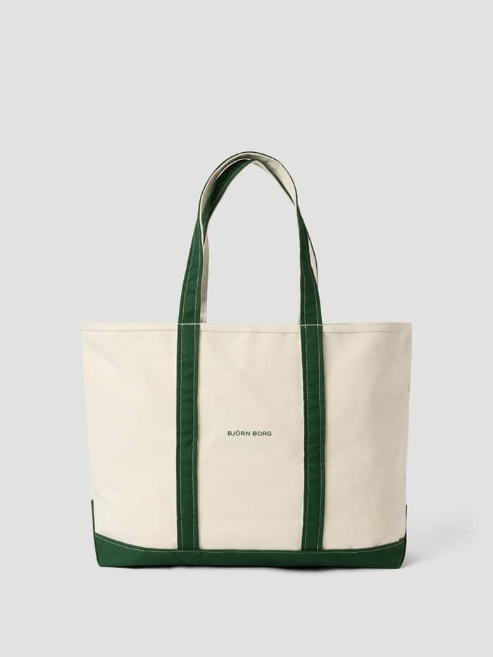 Front view of the Björn Borg Ace Canvas Tote 30L in Egret (White), a cotton canvas tennis bag with a green logo.