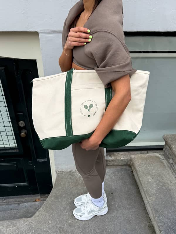 Björn Borg Ace Canvas Tote 30L in Egret (White) carried by a woman, made from cotton for tennis style and performance.