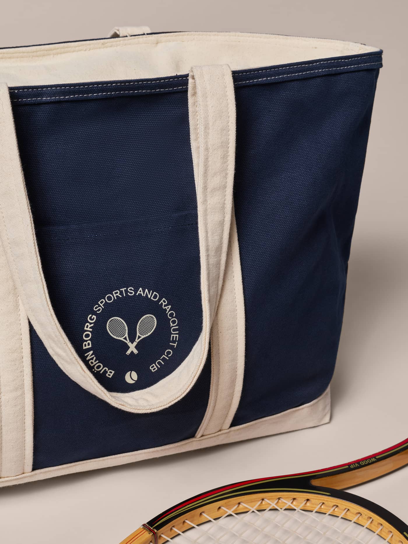 Ace Canvas Tote 27L in Night sky (Navy) cotton canvas featuring a white tennis and racquet club logo on the front. - Image 4