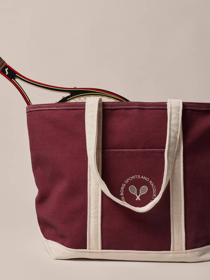 Ace Canvas Tote 27L in Cabernet (Red) cotton canvas with a white logo and off-white handles, designed for tennis.