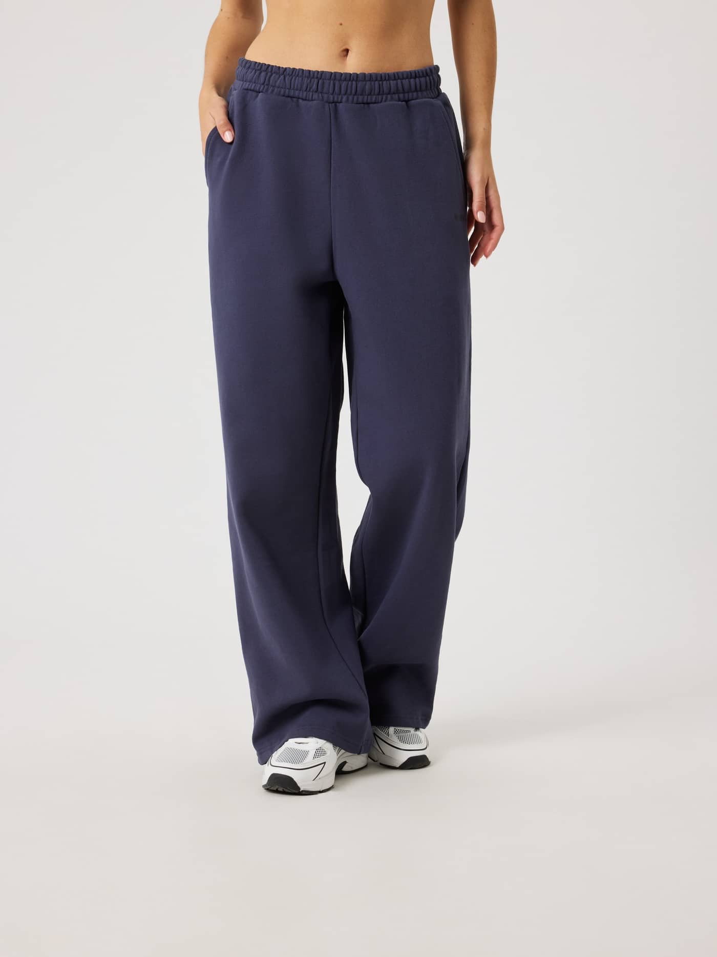 Front view of a model wearing organic cotton Studio Oversized Straight Sweatpants in Odyssey Gray (Navy) for a relaxed fit. - Image 1