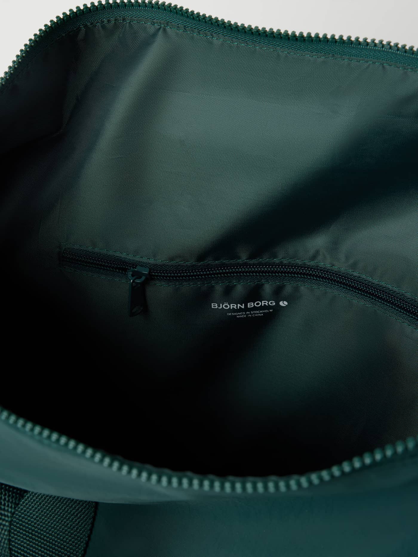Interior view of the Studio Active Sports Bag 25L in Mallard Green (Green) featuring the training pocket and white logo. - Image 3