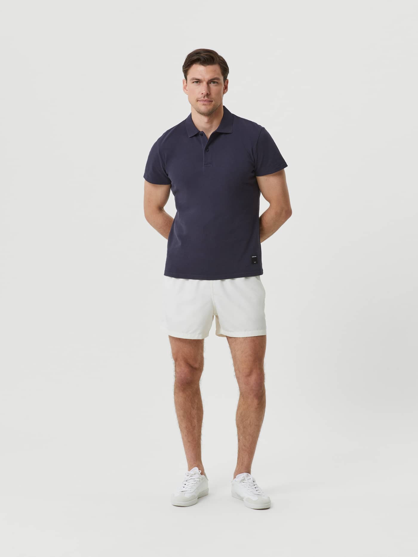 Full-body front view of a man wearing the cotton Björn Borg Polo Shirt in Night sky (Navy) with a classic regular fit. - Image 3