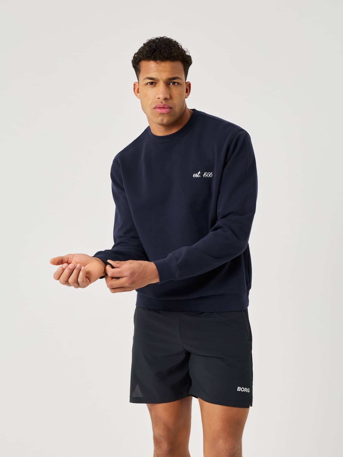 Front view of a man in the cotton Borg Classic Print Sweatshirt in Night Sky (Navy) with a white tennis-inspired print. - Image 2