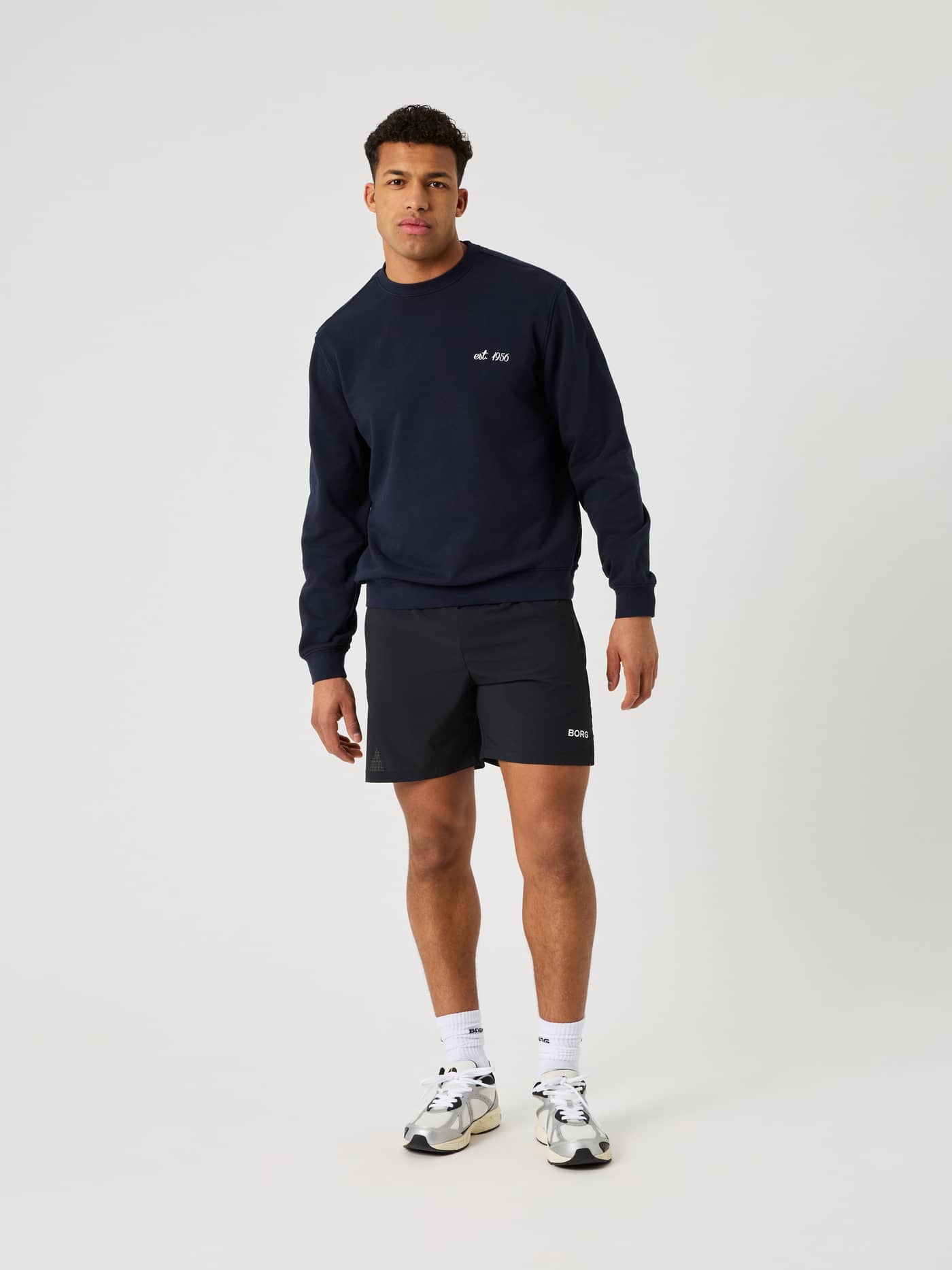 Full-body front view of a man in the cotton Borg Classic Print Sweatshirt in Night sky (Navy) for a stylish tennis look. - Image 3