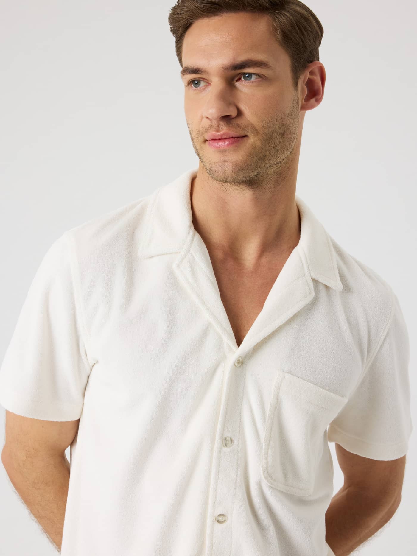 Front view of a man in the Borg Toweling Pool Shirt in Tofu (White), featuring a camp collar and terry toweling fabric. - Image 5