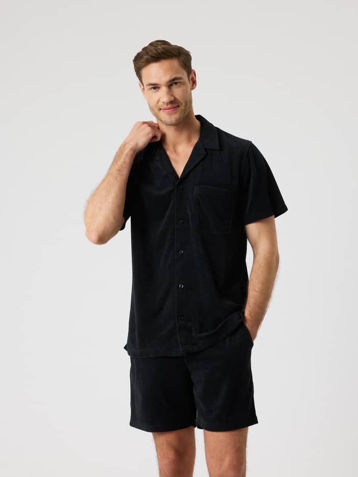 Front view of a man wearing the Borg Toweling Pool Shirt in Black Beauty (Black), featuring soft terry toweling fabric.