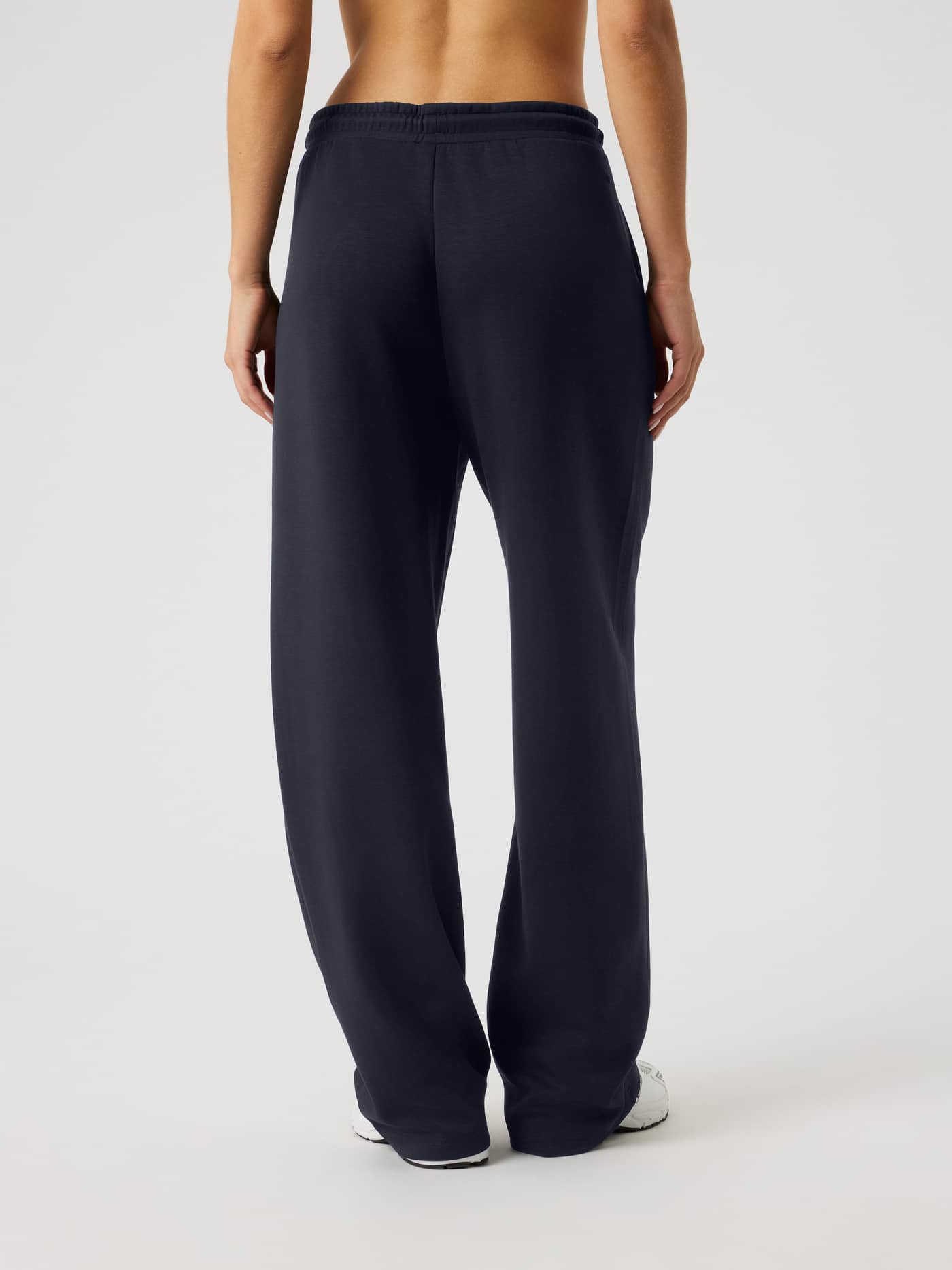 Back view of a woman wearing the Björn Borg Studio Soft Sweatpants in Night Sky (Navy), featuring a relaxed loose fit. - Image 4