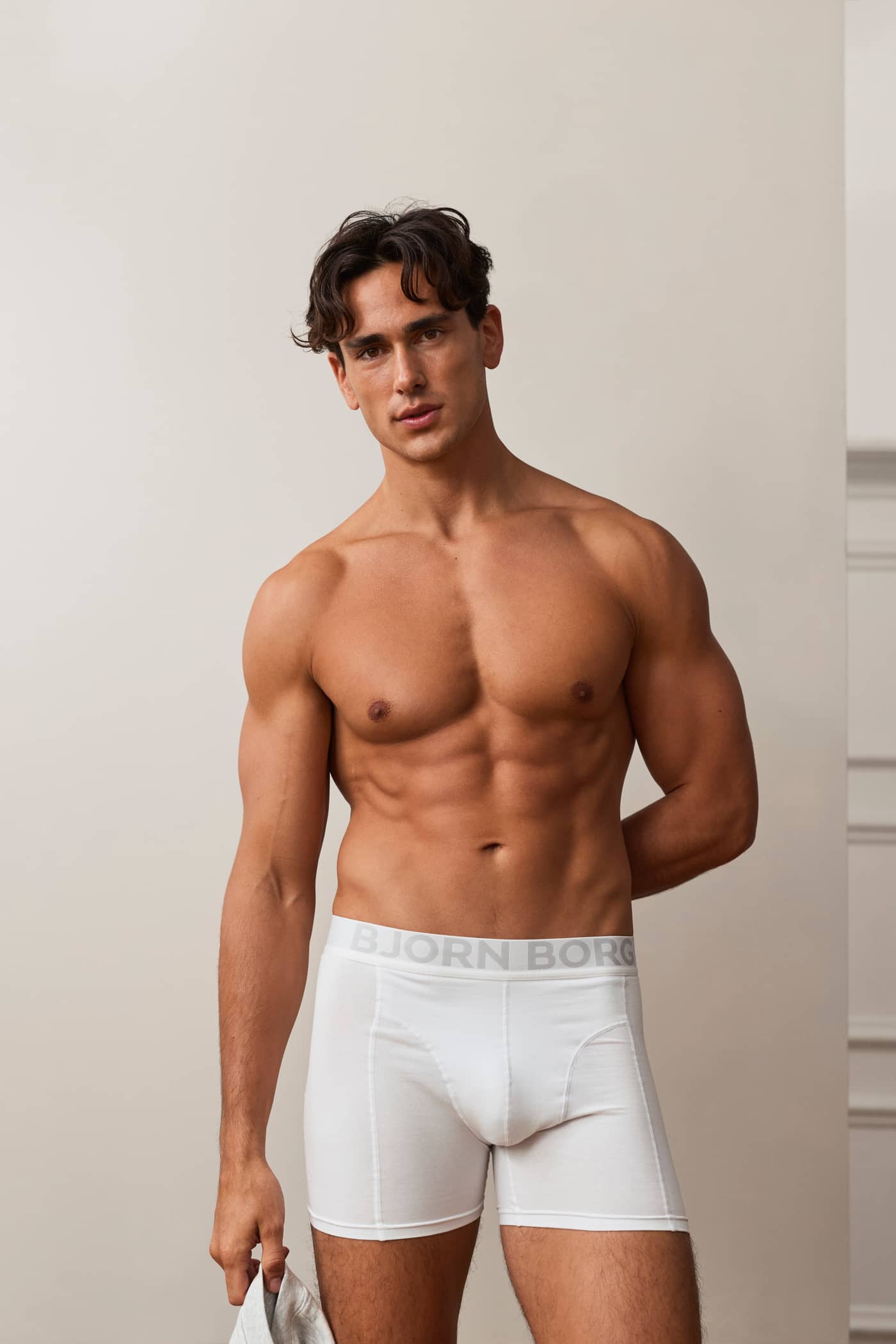 Front view of a model wearing Organic Cotton Stretch Boxers 3-pack in white with an elastic waistband. - Image 2