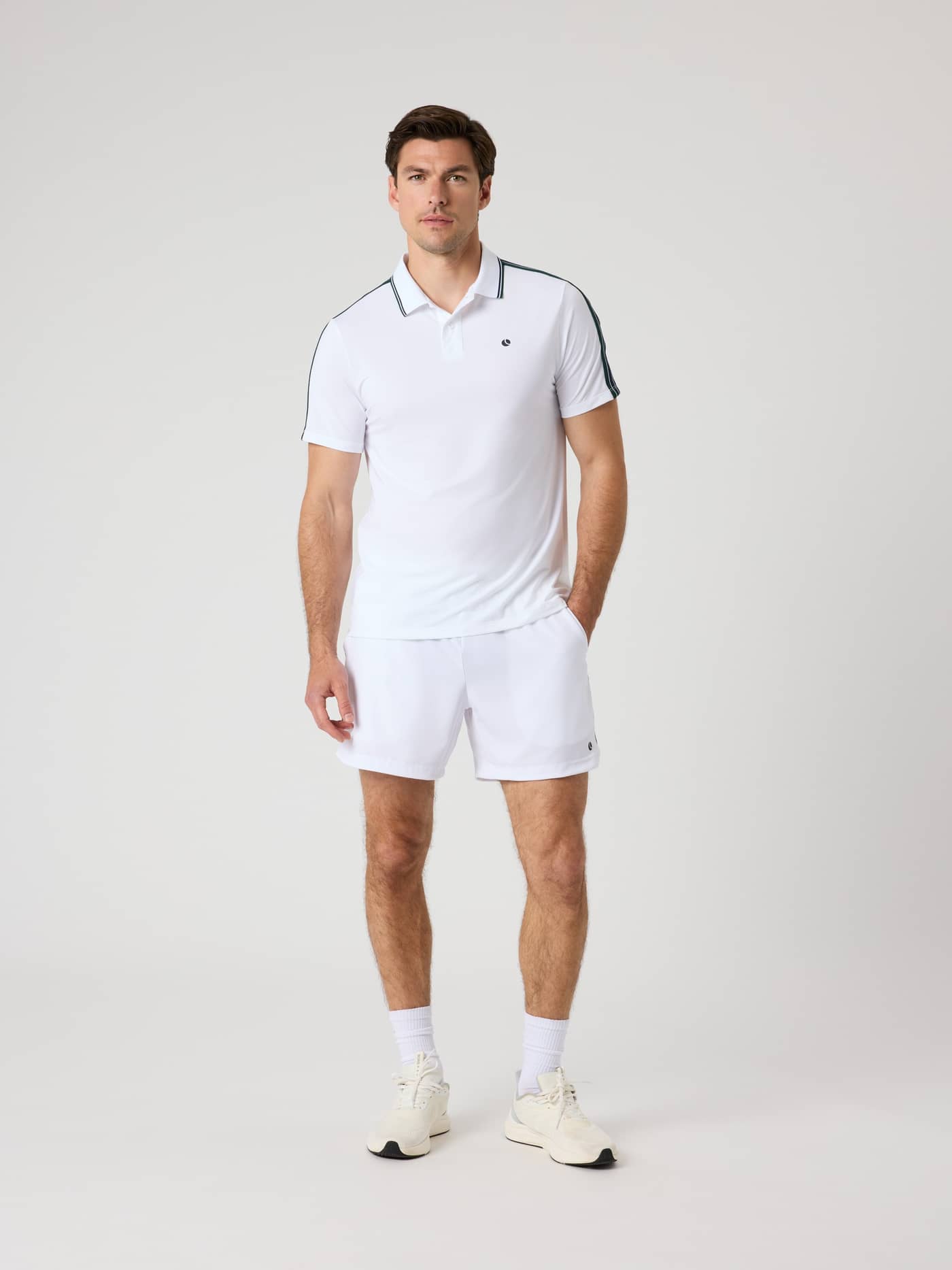 Front view of a man in the Björn Borg Ace Retro Polo Shirt in Brilliant White (White) with a black logo, a tennis style. - Image 3