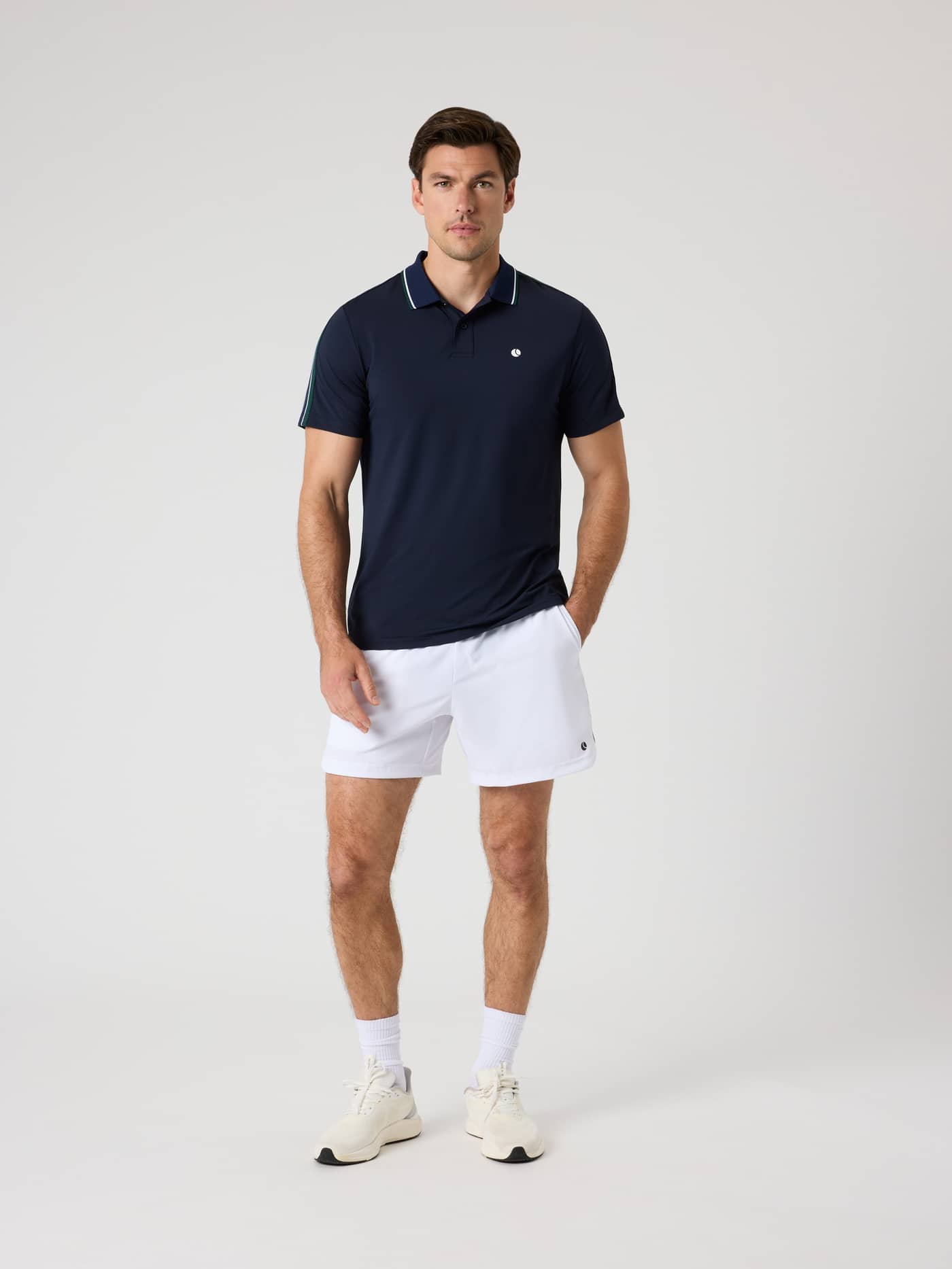 Full-body front view of a man wearing the Björn Borg Ace Retro Polo Shirt in Night sky (Navy) for performance tennis. - Image 3