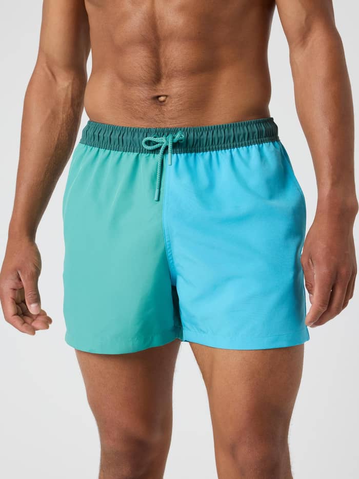 Front view of a man wearing the Björn Borg Blocked Swim Shorts in Sea Blue (Blue) with a functional quick-dry finish.