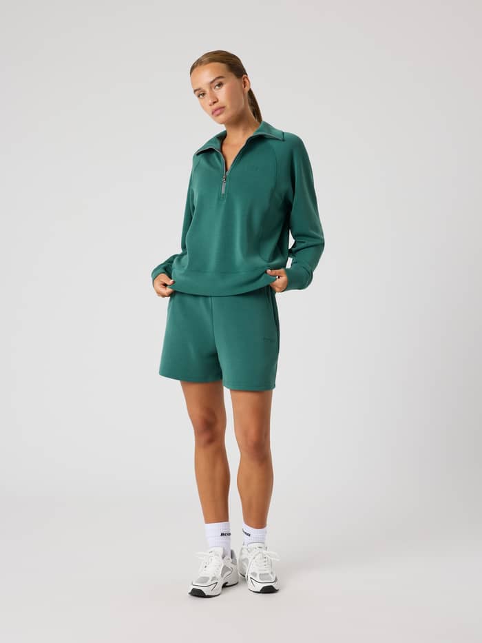 Full-body view of a model wearing the stylish Björn Borg Studio Soft Sweatshorts in Mallard Green (Green) with a loose fit. - Image 3
