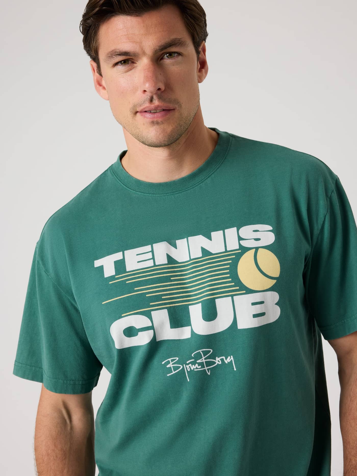 Front view of a man wearing the Mallard Green (Green) Borg Classic Print T-Shirt, a 100% cotton top with a tennis graphic. - Image 5