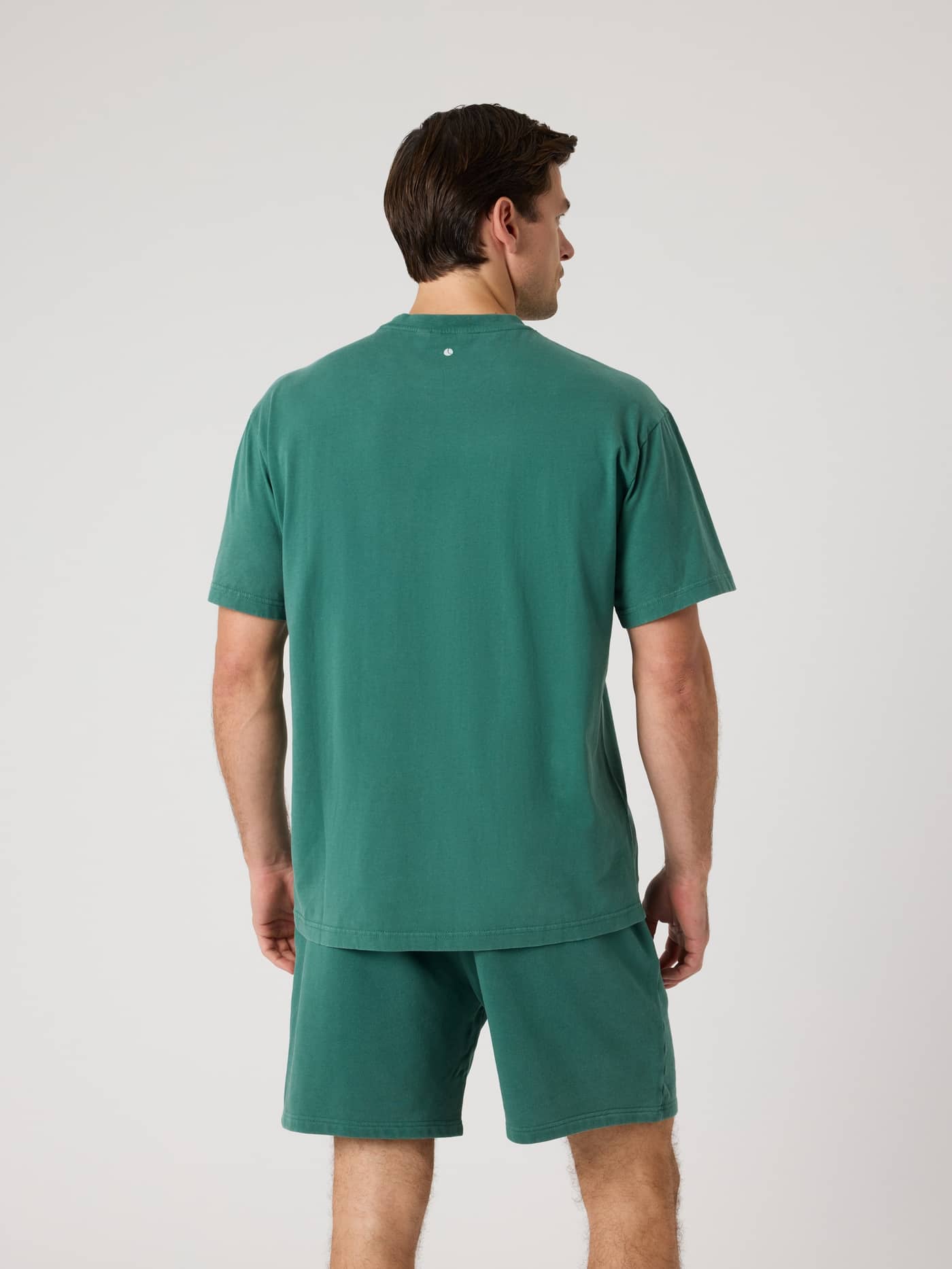 Back view of a man wearing the cotton Björn Borg Classic Print T-Shirt in Mallard Green (Green) with a tennis ball print. - Image 2