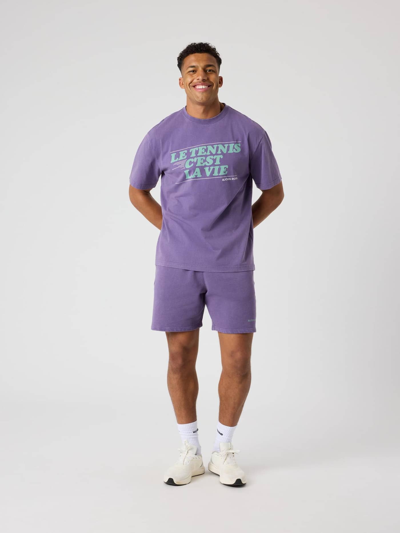 Full-body front view of a man wearing the 100% cotton Borg Classic Print T-Shirt in Mystical (Purple) with tennis graphics. - Image 3