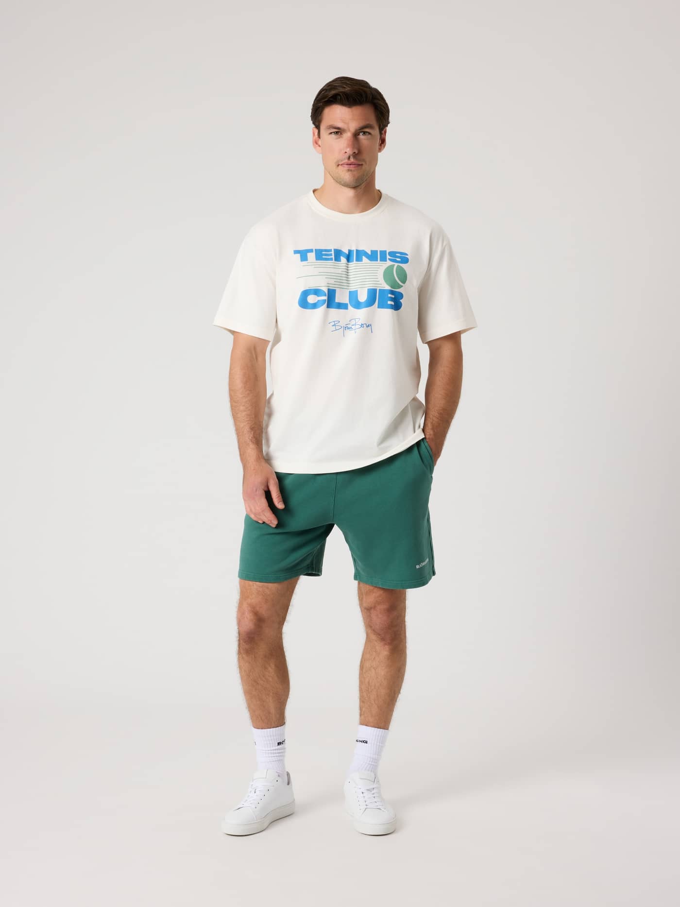 Full-body front view of a man wearing the cotton Borg Classic Print T-Shirt in Tofu (White) with a tennis graphic. - Image 4