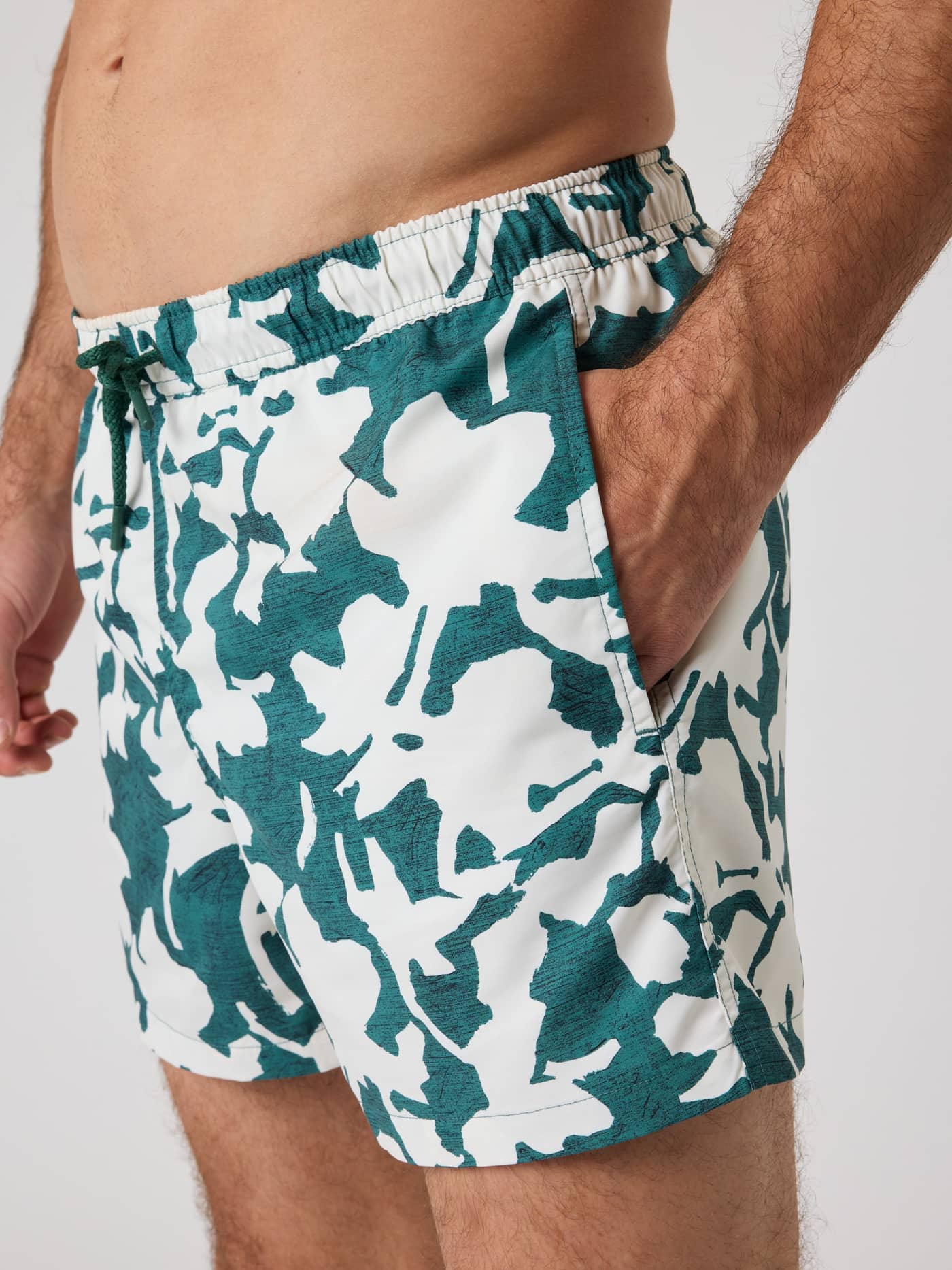 Side view of a man wearing the Björn Borg Print Swim Shorts in Mediterranean 1 (green), featuring a bold digital print. - Image 5