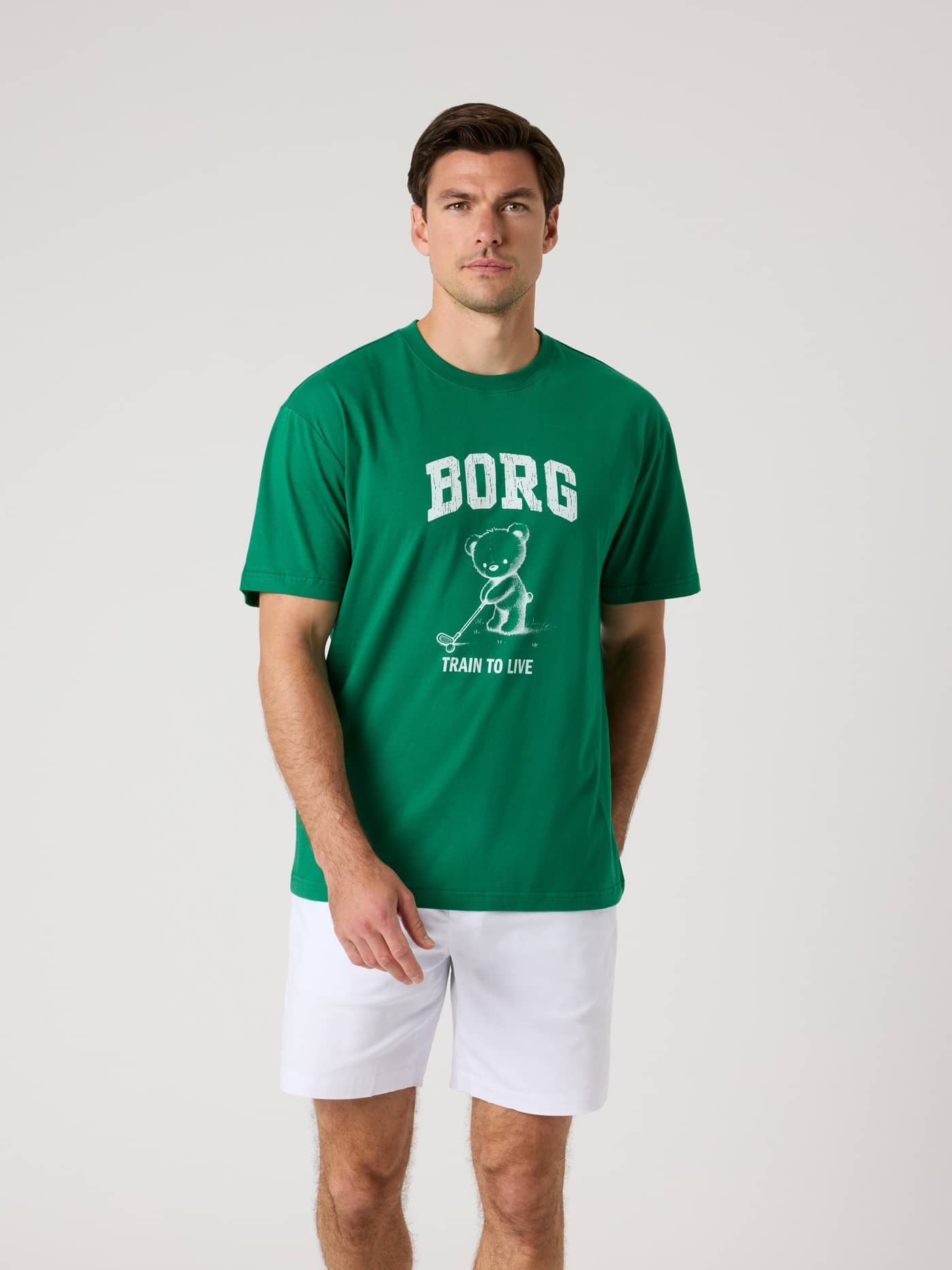 Front view of a man wearing the cotton Borg Classic Print T-Shirt in Verdant Green (Green) with a white golf graphic. - Image 2