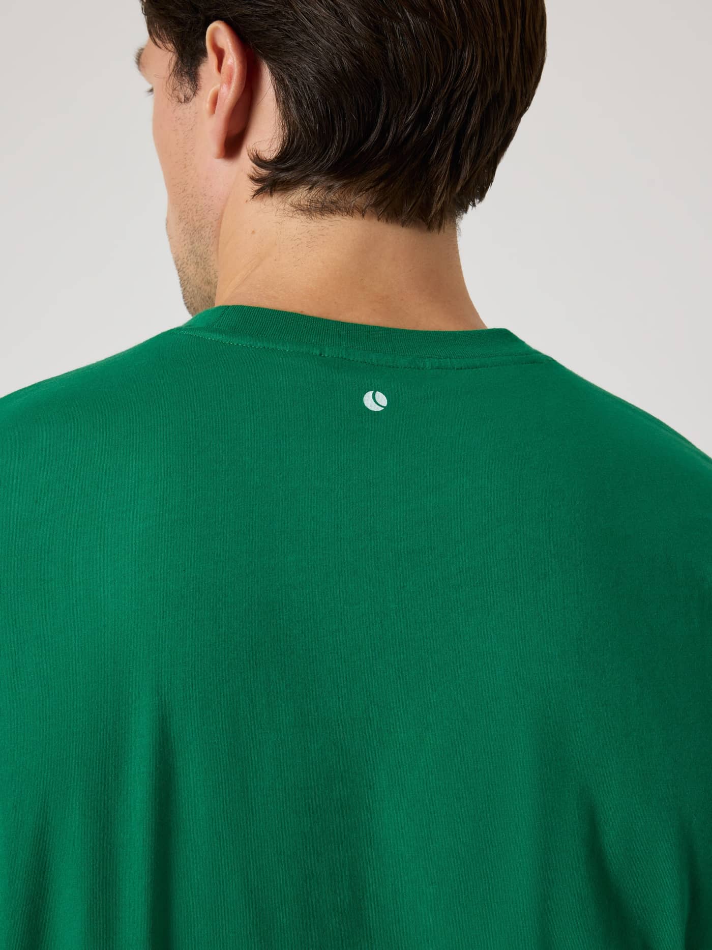 Back view of the functional cotton Björn Borg Classic Print T-Shirt in Verdant Green (Green) with a white tennis ball print. - Image 5
