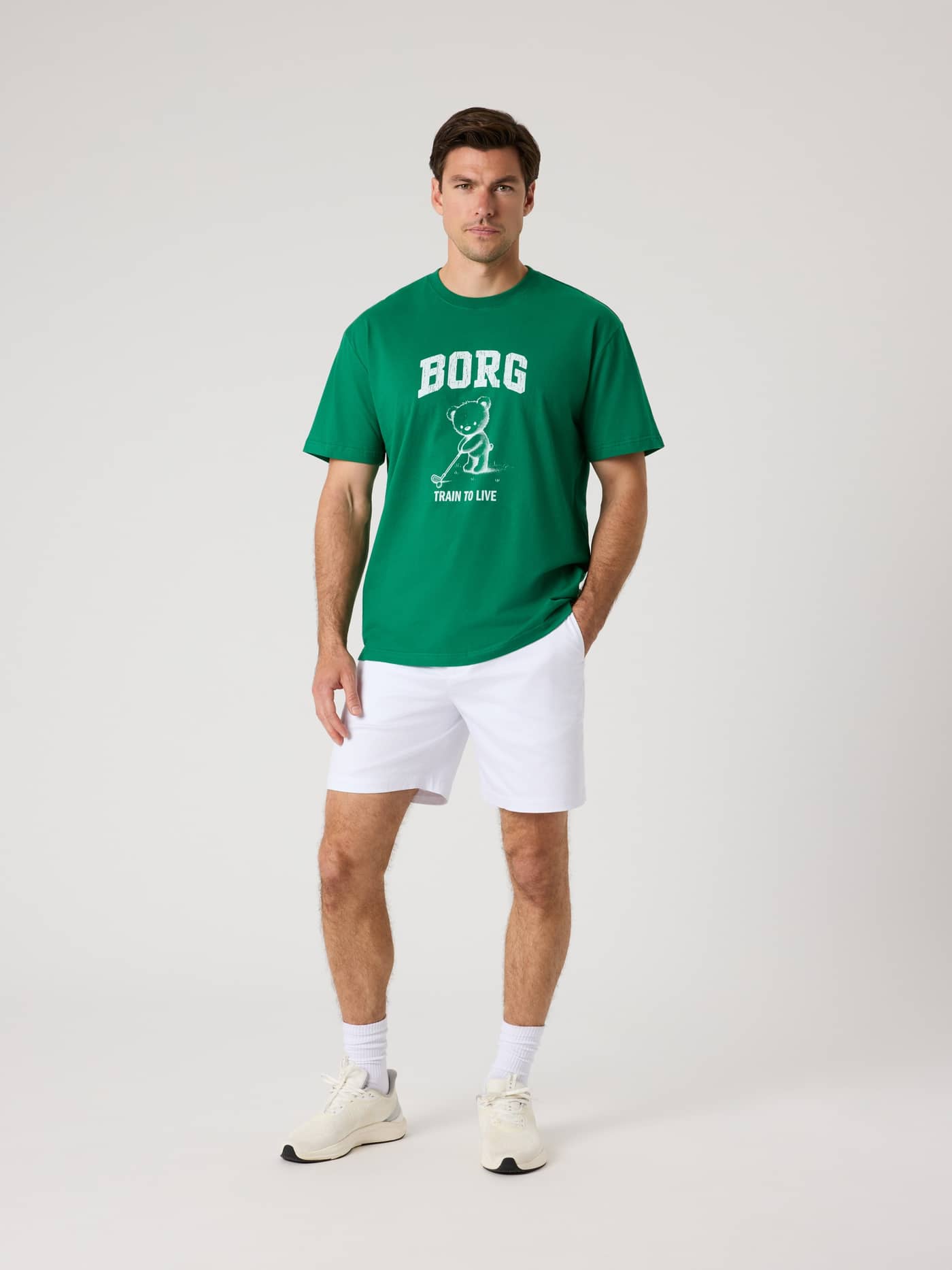Front view of a man wearing the cotton Borg Classic Print T-Shirt in Verdant Green (Green) with a white golf graphic. - Image 4