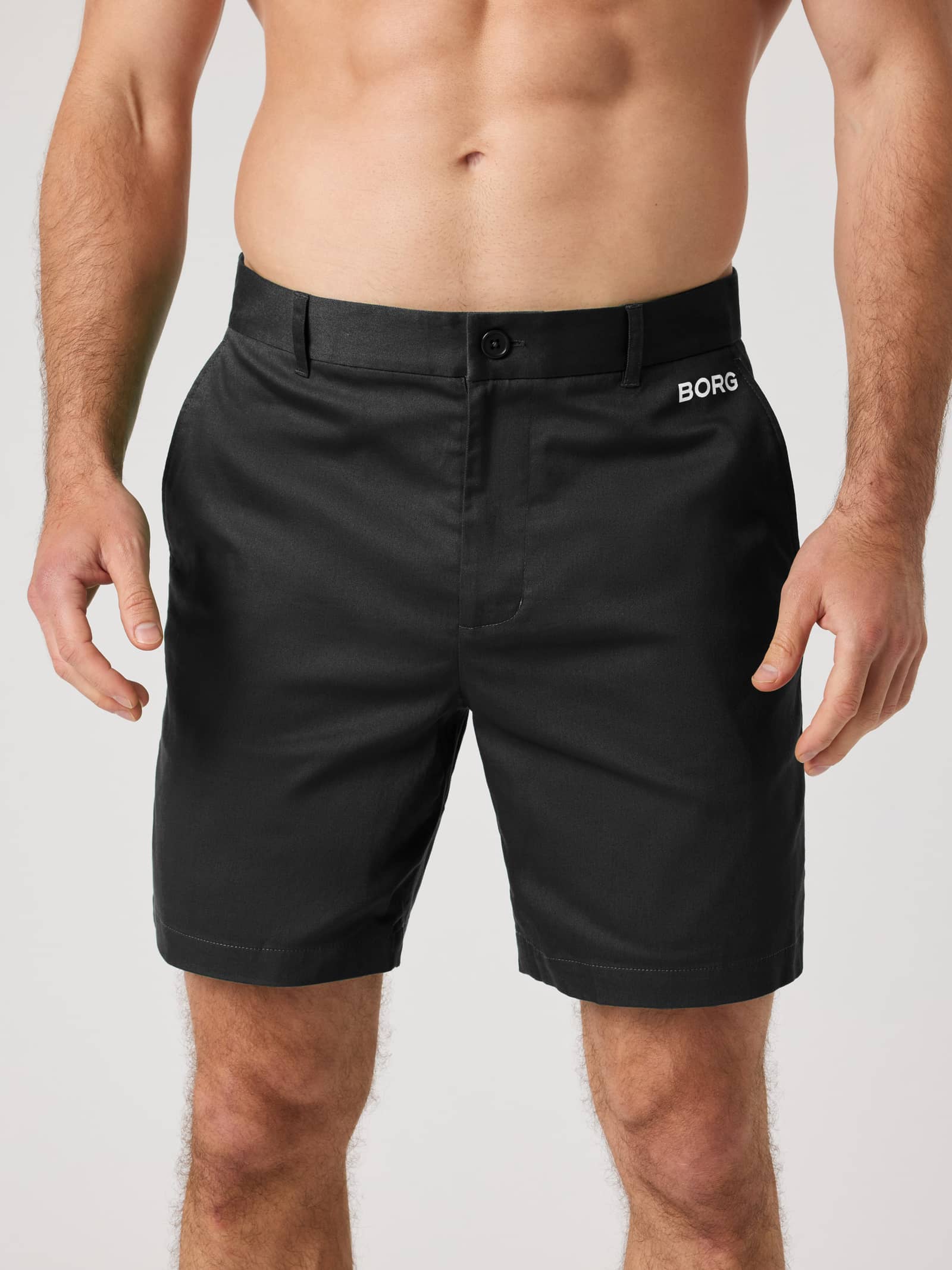 Front view of a man wearing the Borg Golf Chinos Shorts in Black Beauty (Black), featuring stretchy cotton twill. - Image 1