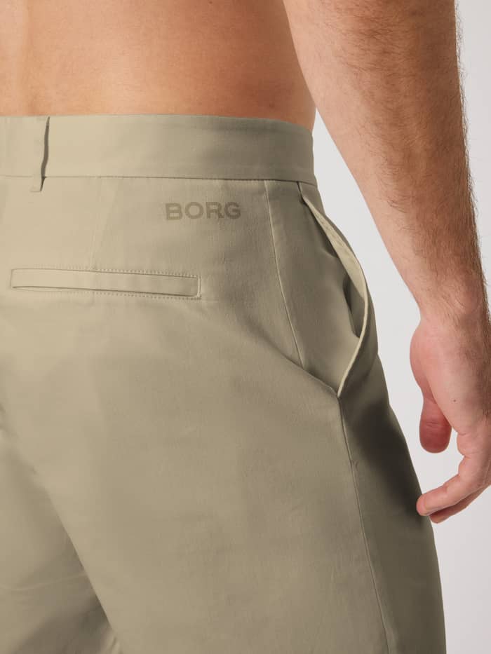Close-up of the Safari (Beige) Borg Golf Chinos Shorts, featuring a tonal logo and pockets for golf performance. - Image 4