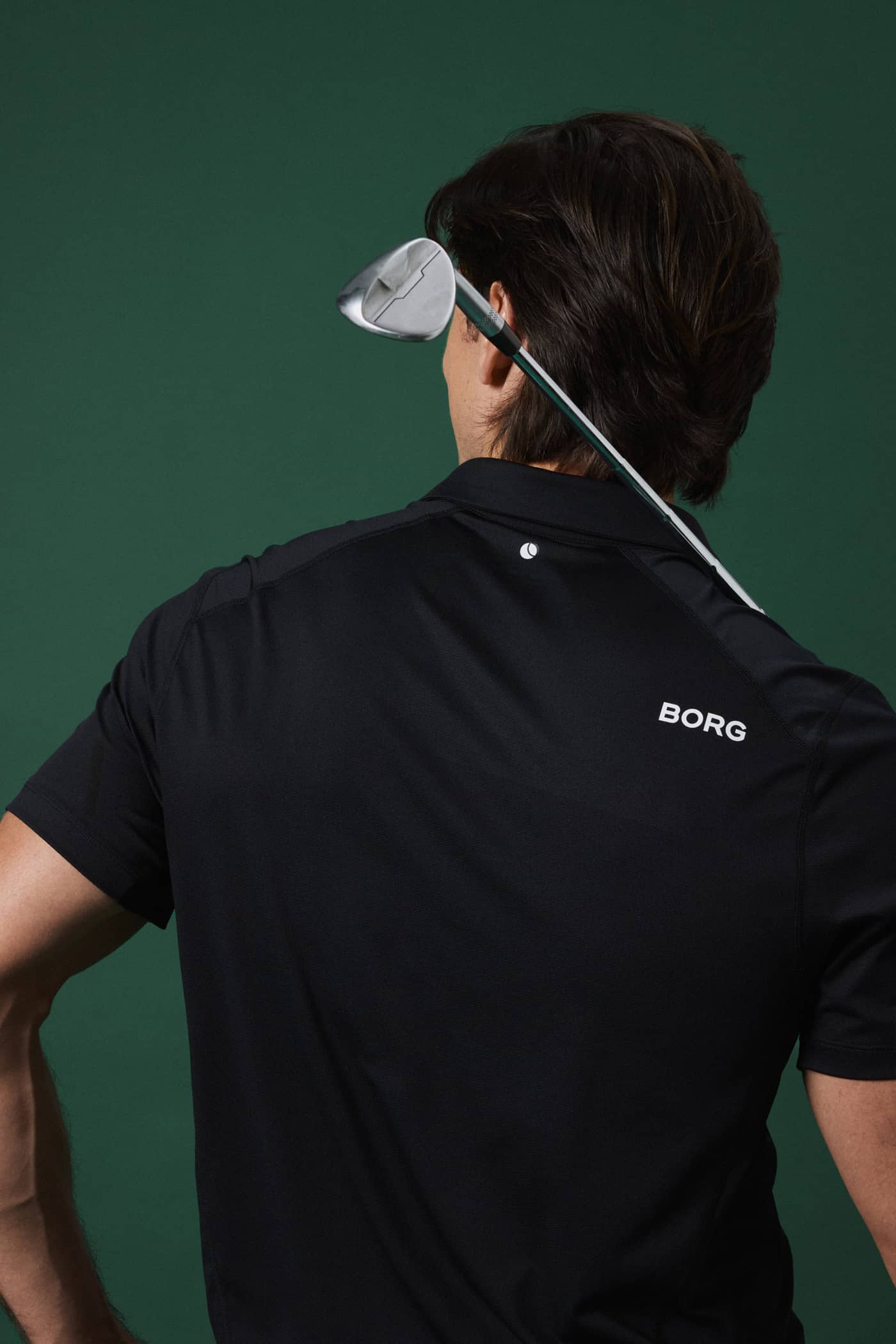Back view of a man in the Borg Golf Polo Shirt in Black Beauty (Black), featuring a stylish and functional fit for golf. - Image 2