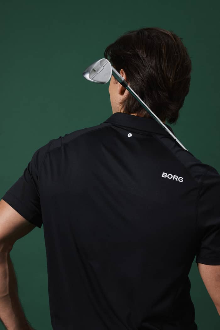 Back view of a man in the Borg Golf Polo Shirt in Black Beauty (Black), featuring a stylish and functional fit for golf. - Image 2