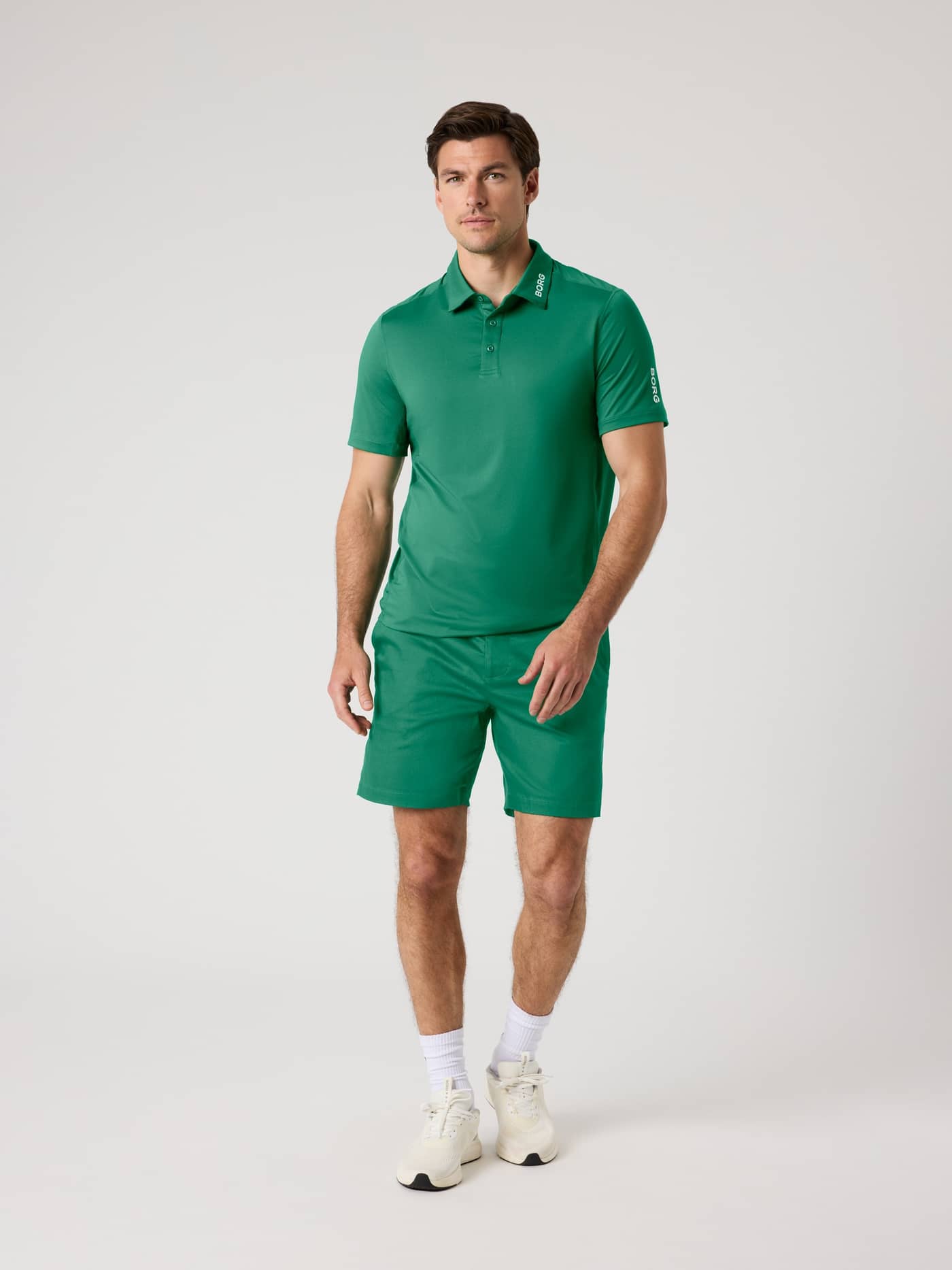 Full-body front view of a man in the Verdant Green (Green) Borg Golf Polo Shirt, featuring style and function for golf. - Image 3