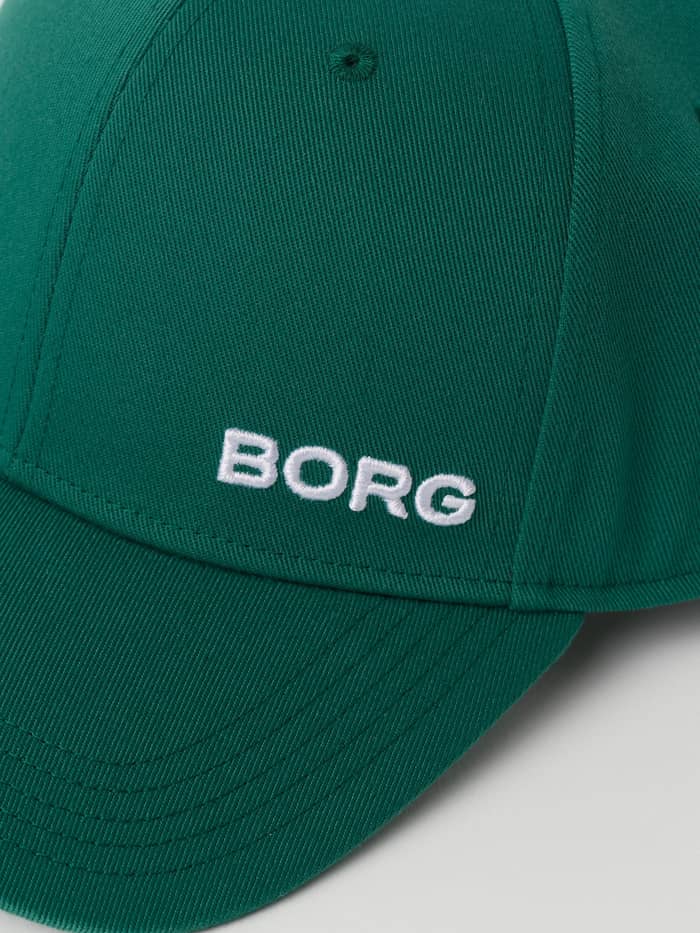 Close-up of the recycled polyester Borg Course Cap in Verdant Green (Green), featuring white BORG embroidery for golf. - Image 4