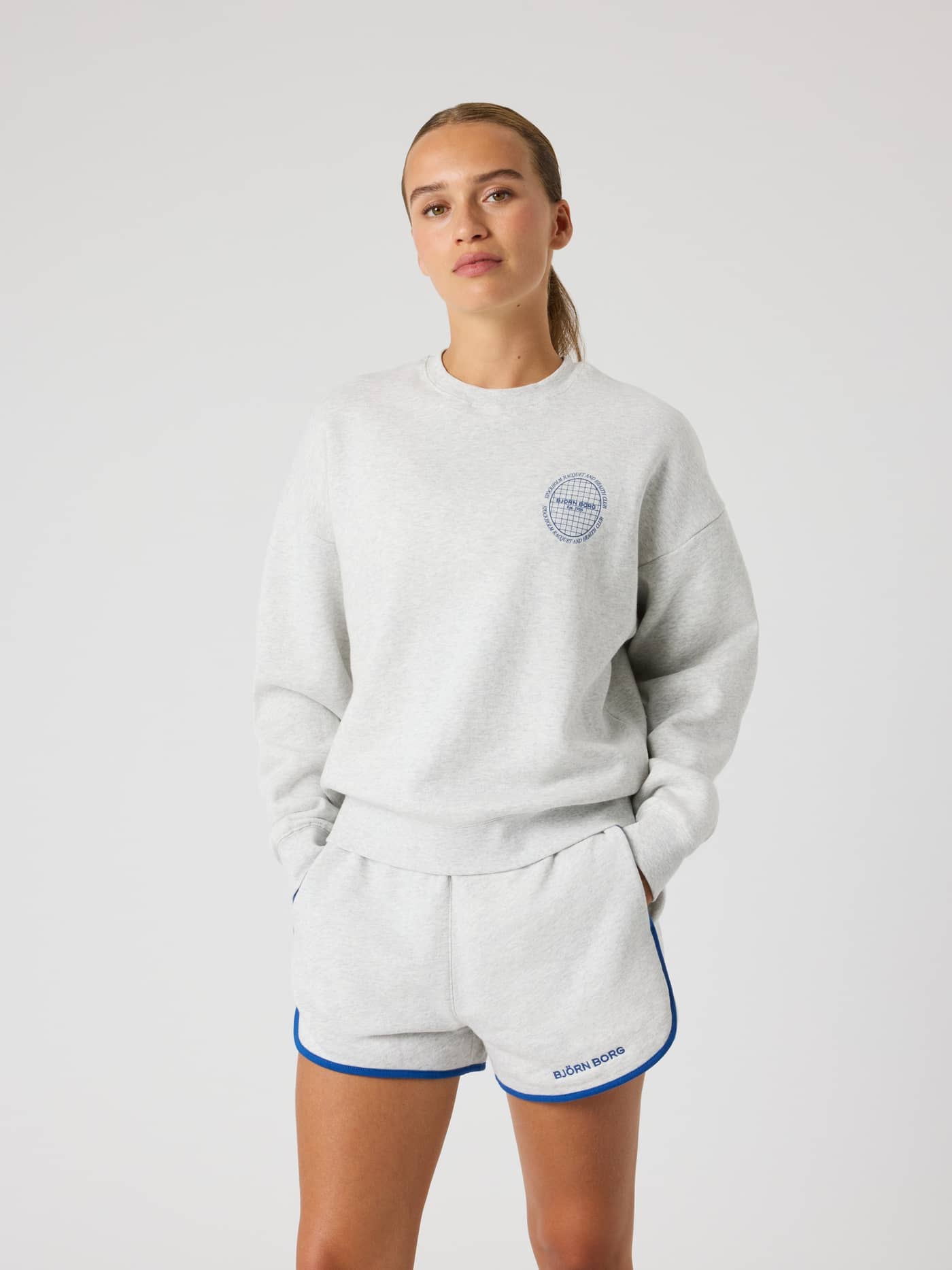 Front view of a woman wearing the oversized Borg Boyfriend Sweatshirt in Ultra Light Grey Melange (Grey). - Image 2