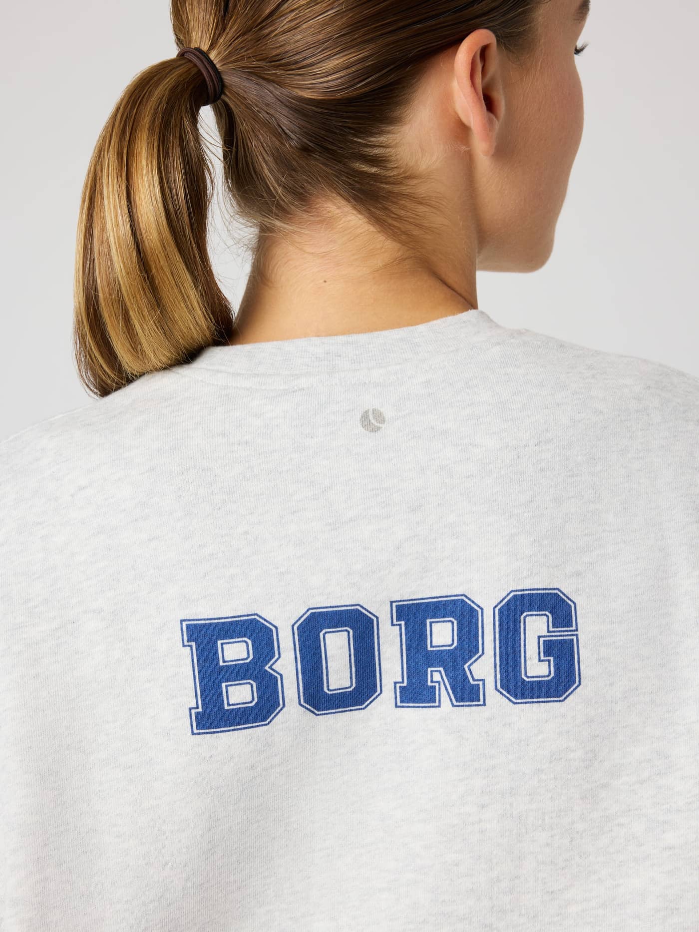 Back view of the oversized cotton-blend Borg Boyfriend Sweatshirt in Ultra Light Grey Melange (Grey) with a blue logo. - Image 5