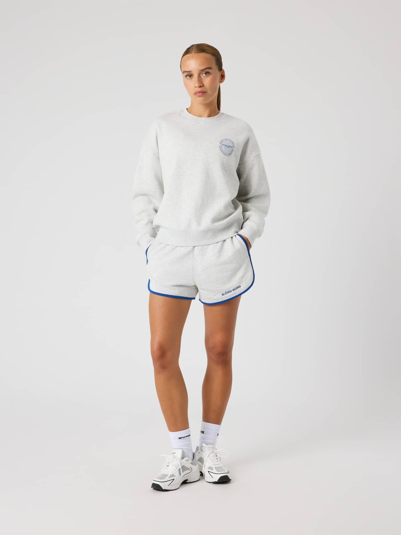 Front view of a model in the oversized Borg Boyfriend Sweatshirt in Ultra Light Grey Melange (Grey) with matching shorts. - Image 4