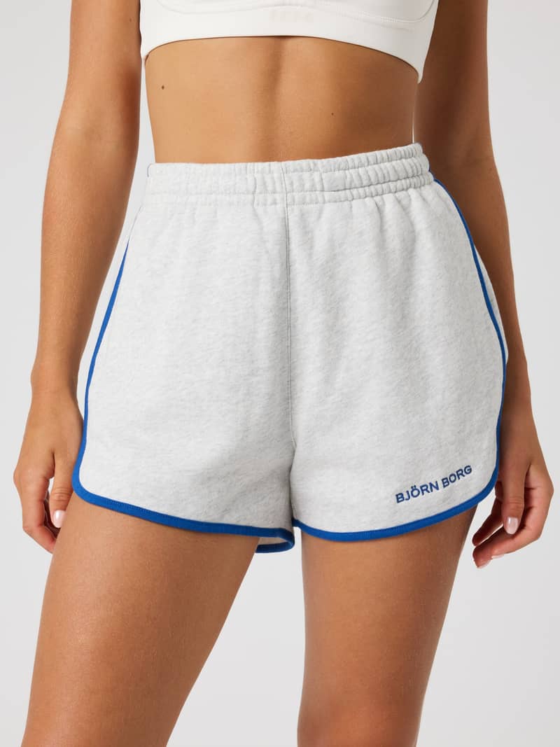 Front view of a model wearing Björn Borg Sweatshorts in Ultra Light Grey Melange (Grey) with a blue logo and regular fit.