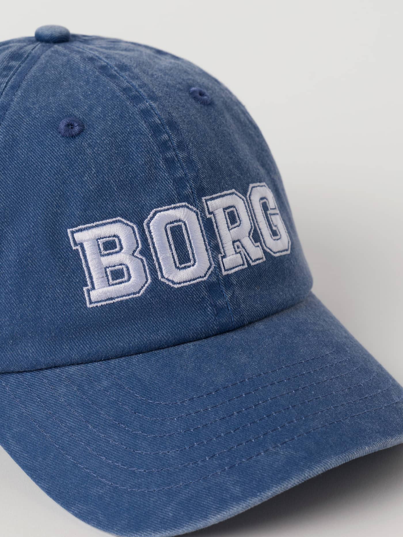 Detailed close-up of the washed Monaco Blue (Blue) Borg Washed Bold Logo Cap featuring white BORG embroidery. - Image 3