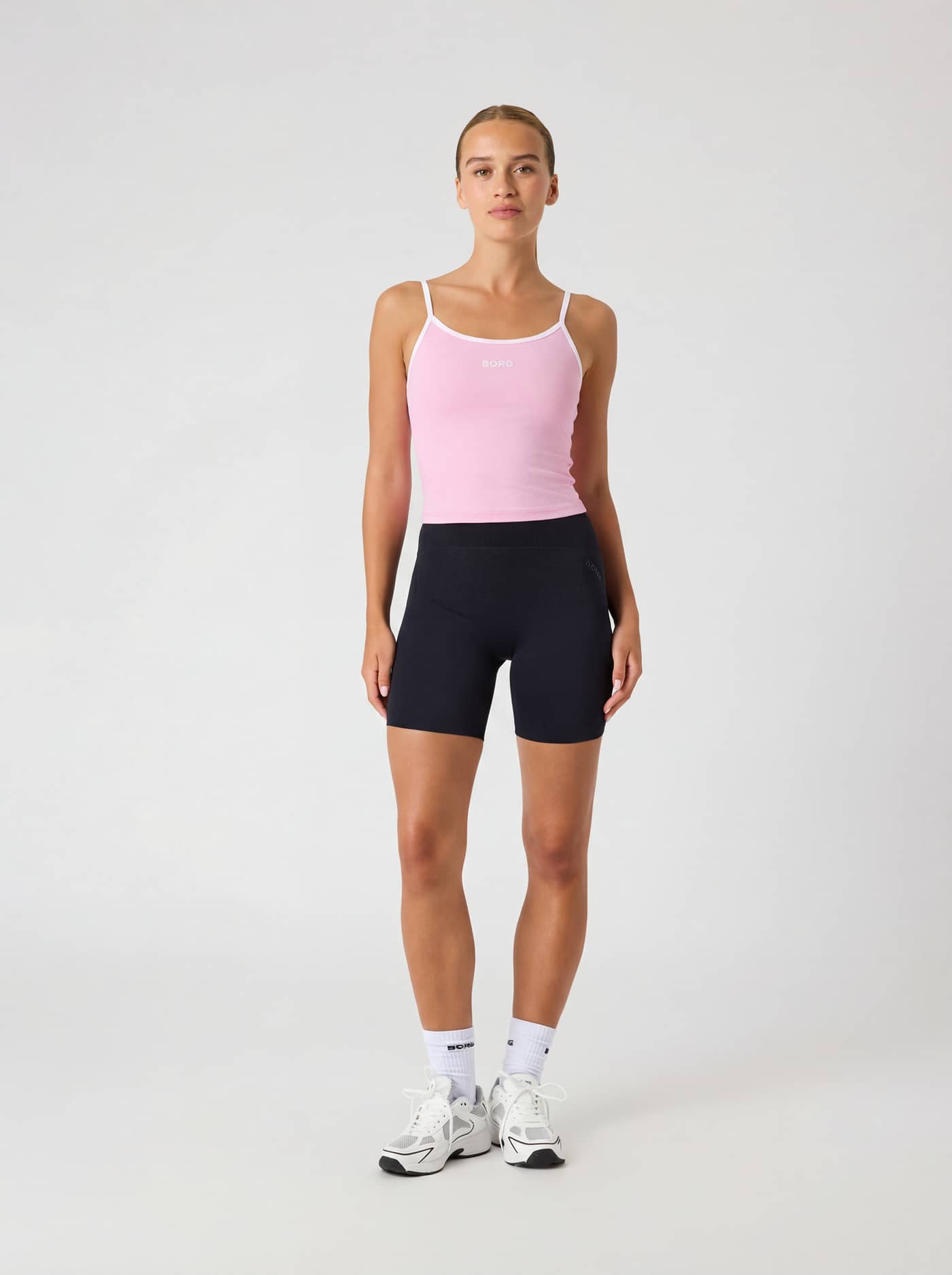Full-body front view of a woman wearing the Borg Cropped Strap Tank Top in Pink Lady (Pink) for training. - Image 3