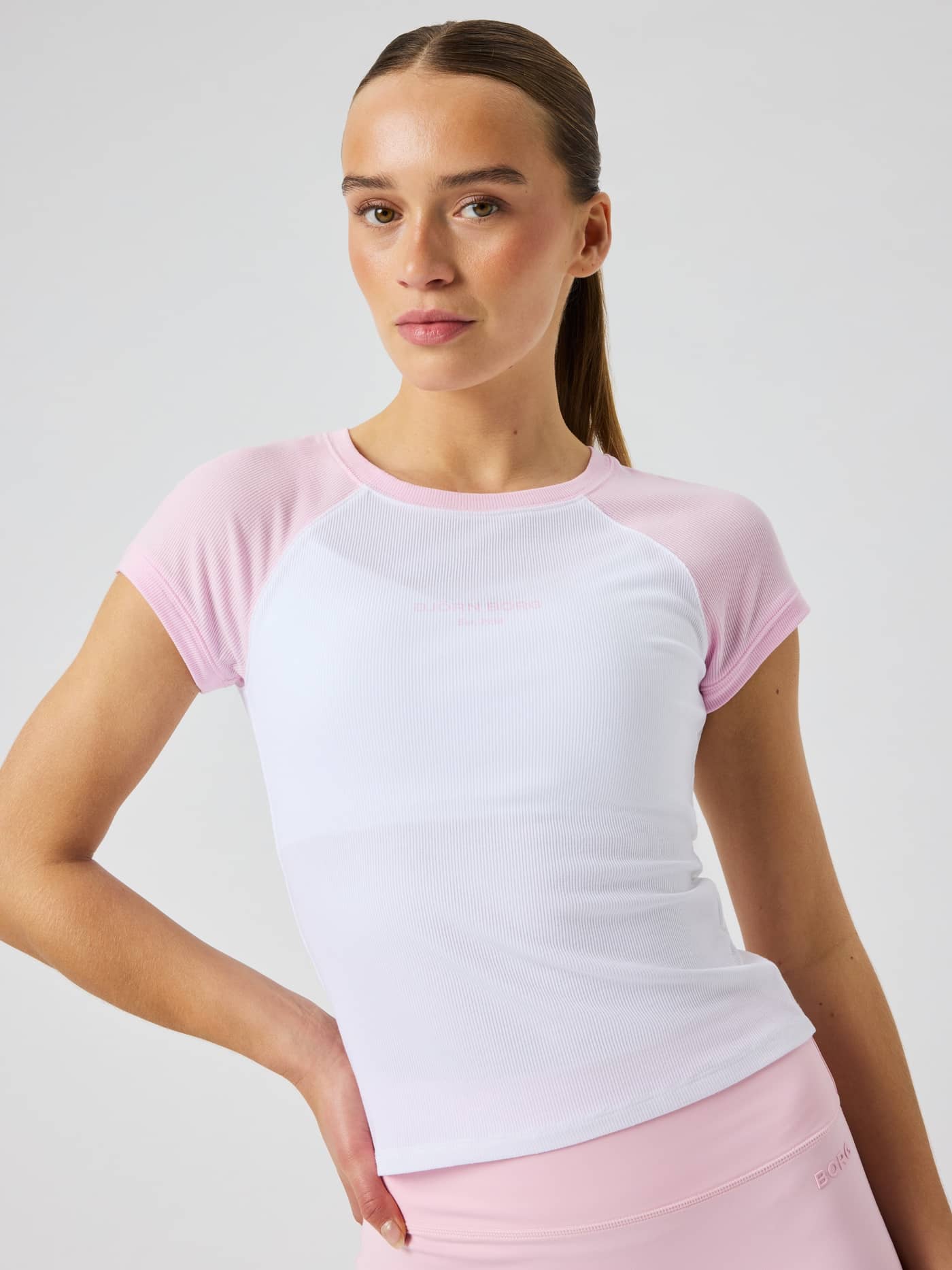 Front view of a model wearing the slim-fit, ribbed modal Studio Ringer T-Shirt in Pink Lady (Pink) with a tennis style. - Image 5