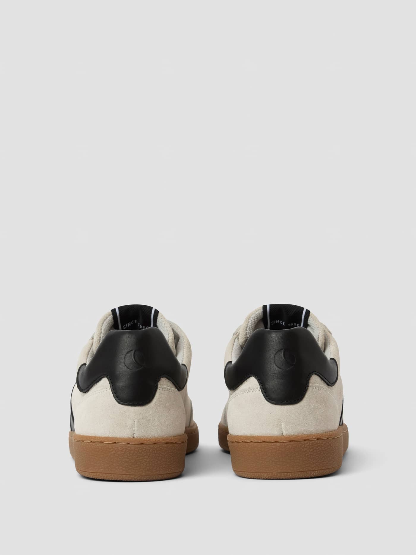 Back view of the white and black Women's Grace Leather Sneakers, featuring a stylish tennis-inspired fit and black logo. - Image 3