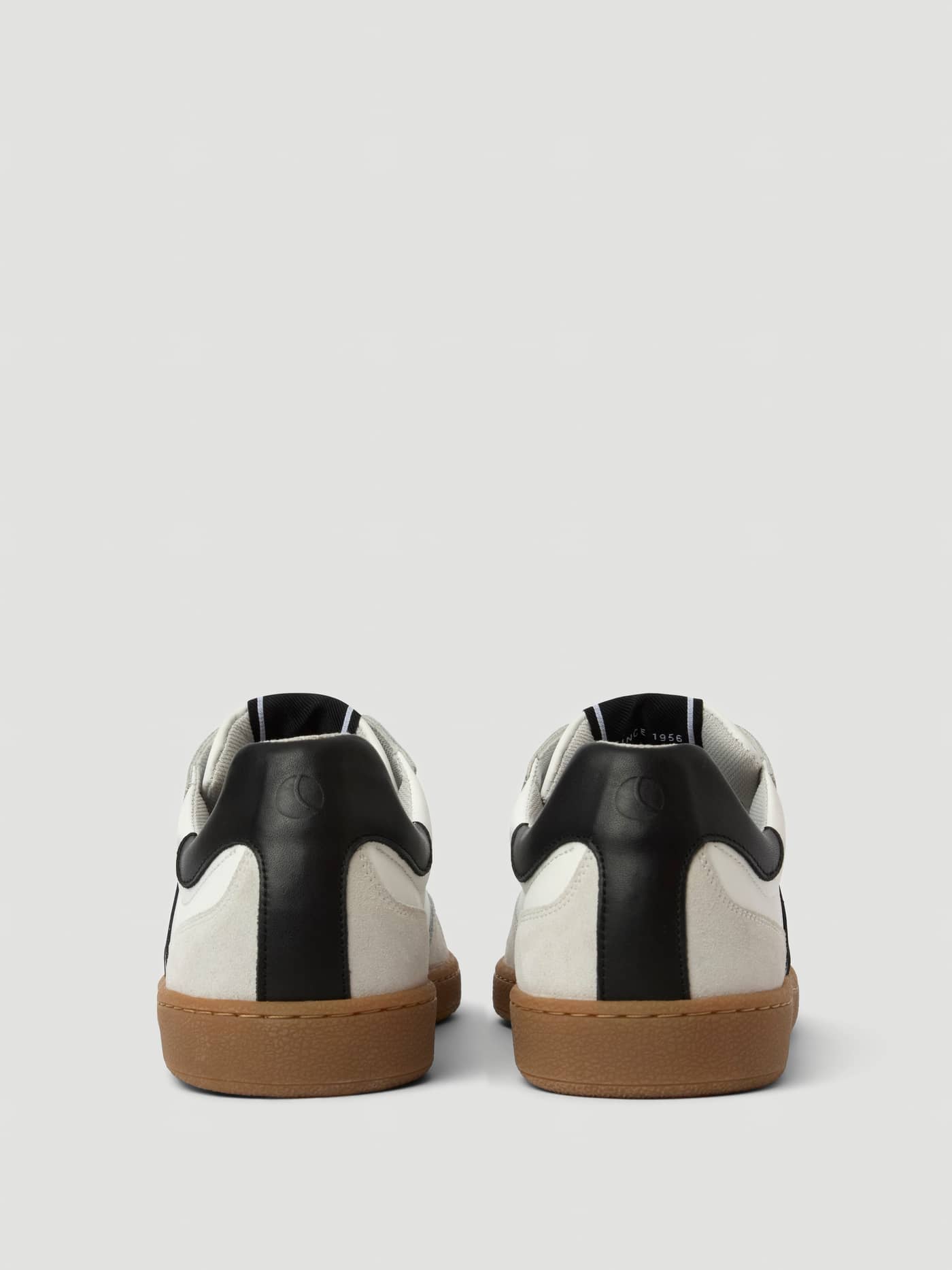 Back view of Men's Legacy Leather Sneakers in white and black leather, combining tennis style and athletic function. - Image 3