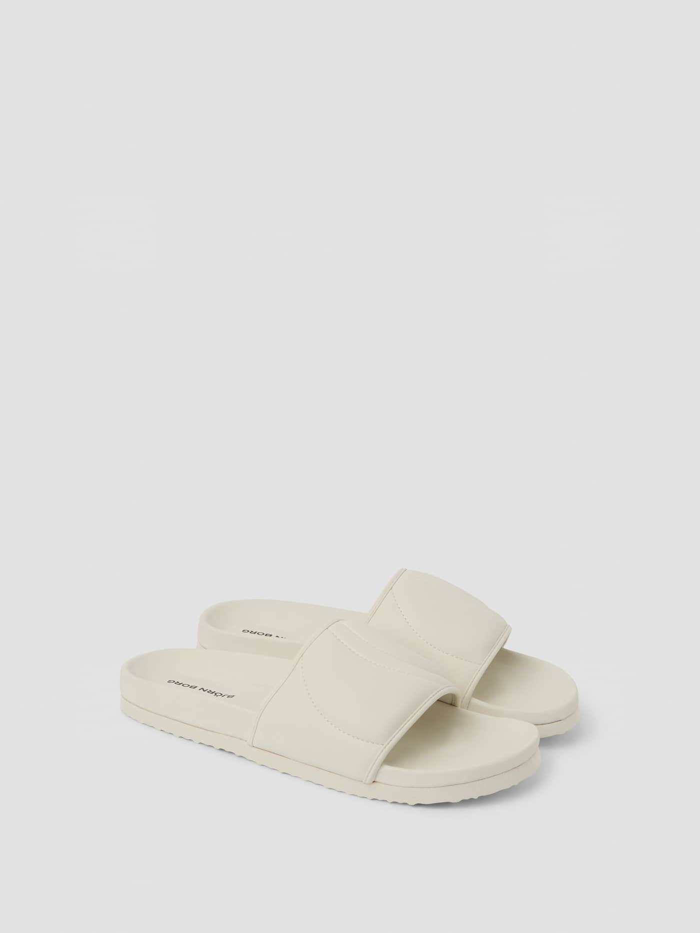 Three-quarter view of the white Unisex Timeout Slides made from durable TPU for lightweight leisure wear. - Image 1