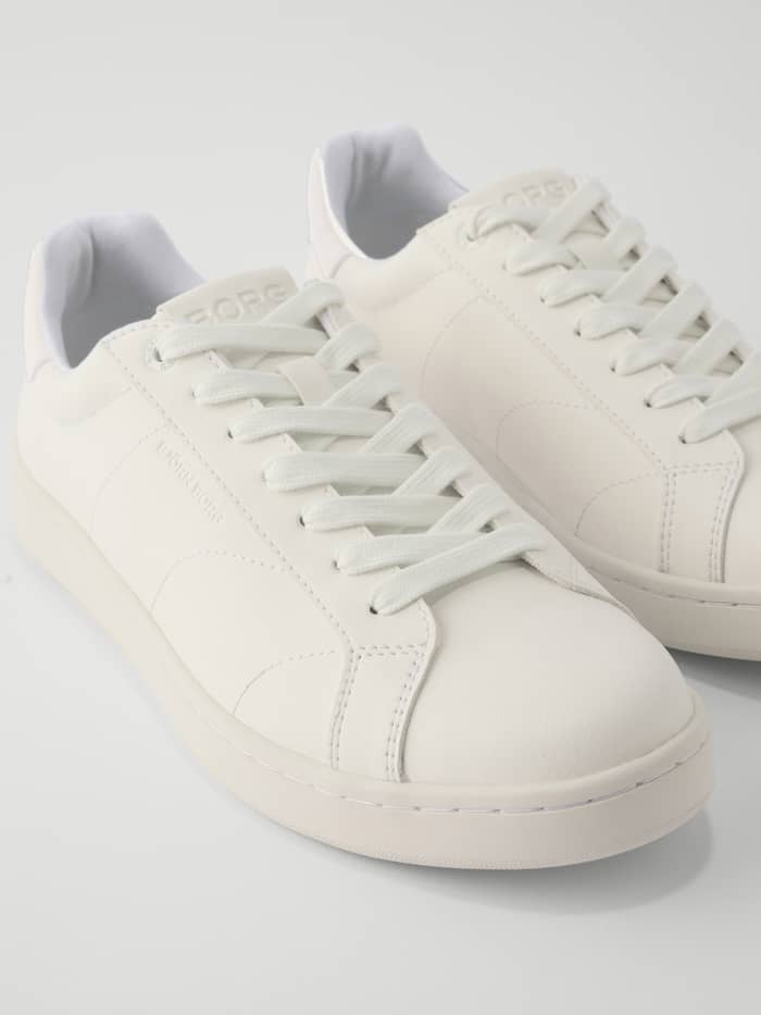 Close-up of the Unisex Deuce Sneakers in White.